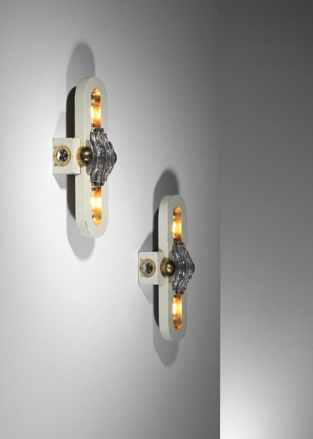 Rare pair of Italian sconces from the 40's / 50's. Very original shape with a white lacquered metal base (original paintwork), solid brass interior to reflect the light and the center of the sconces decorated with cabochon-like thick glass elements.