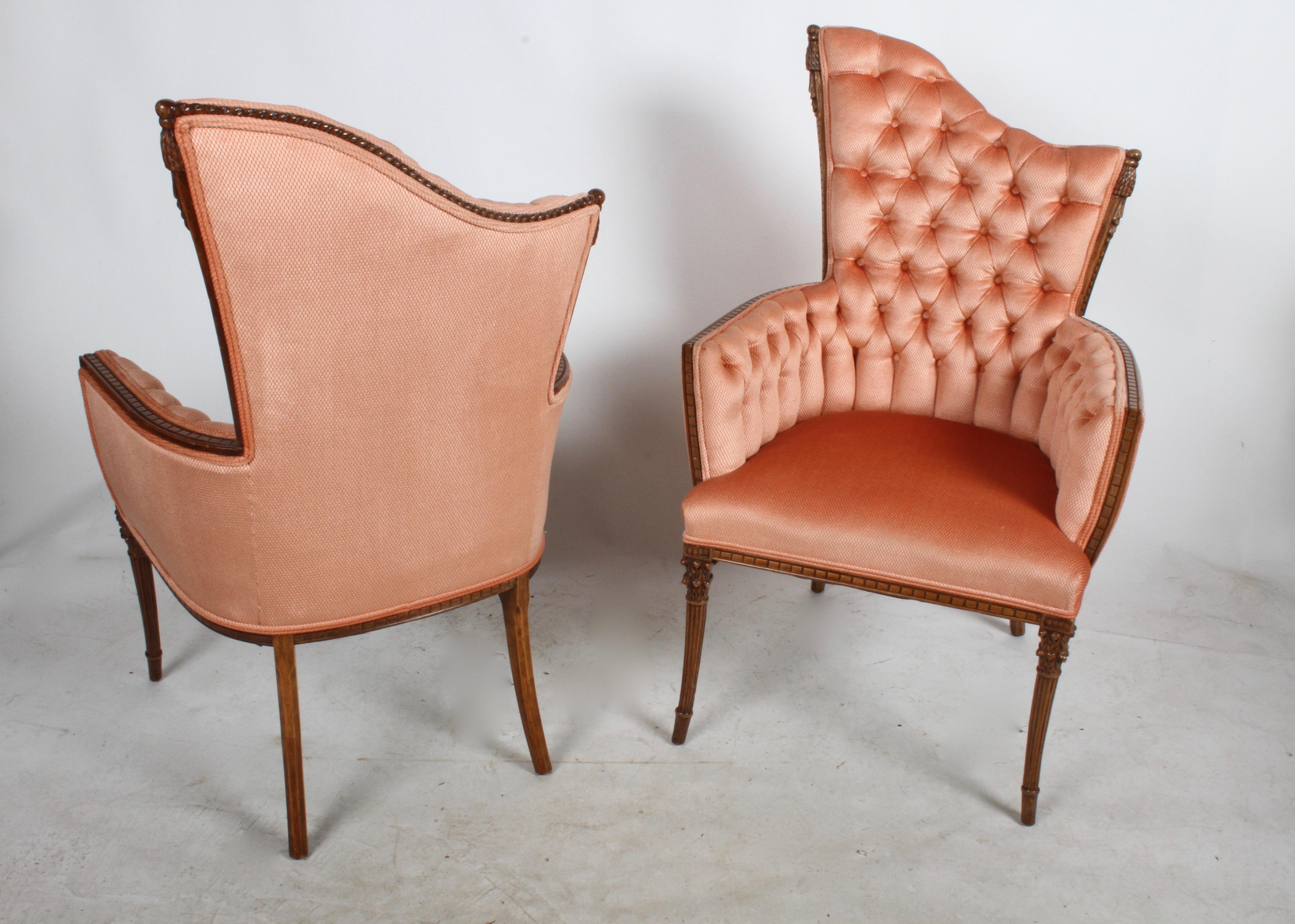 Grosfeld House 1940s Hollywood Regency design asymmetrical back tufted arm chairs with tassel and column details. These were restored sometime in the 1990s, salmon fabric is clean, foam is good.