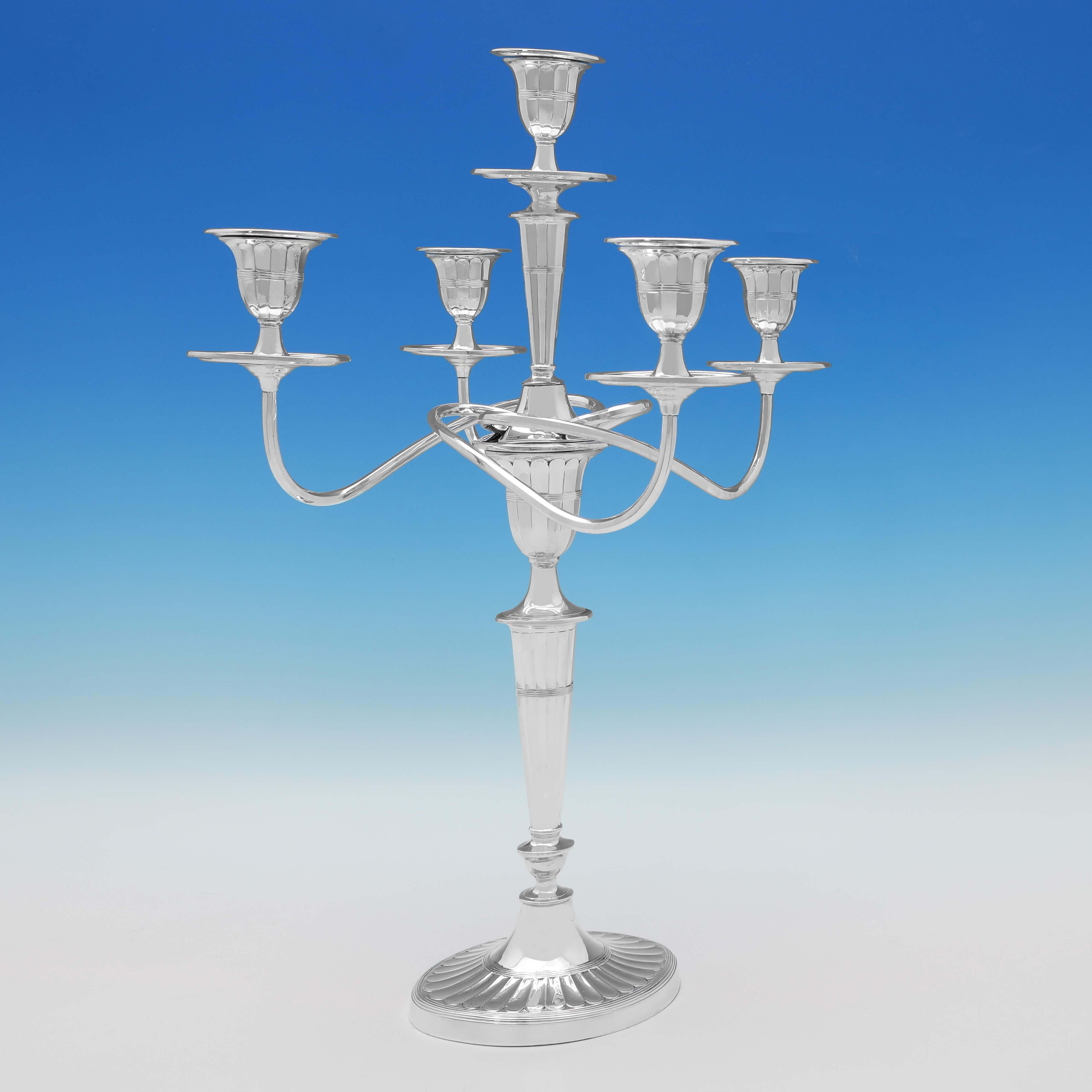 Hallmarked in Sheffield in 1901 by Hawksworth Eyres & Co., this handsome, Victorian pair of antique sterling silver candelabra, are in the 'batwing' style, and will hold 5 candles. Each candelabrum measures 19.5