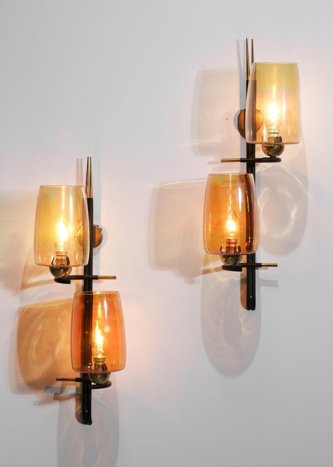 Pair of French wall lights from the 50s/60s in the Scandinavian design style of the time. Black lacquered metal structure, wall plate and solid brass finish. Shade in iridescent glass coloured in a cameo of orange. Excellent vintage condition,