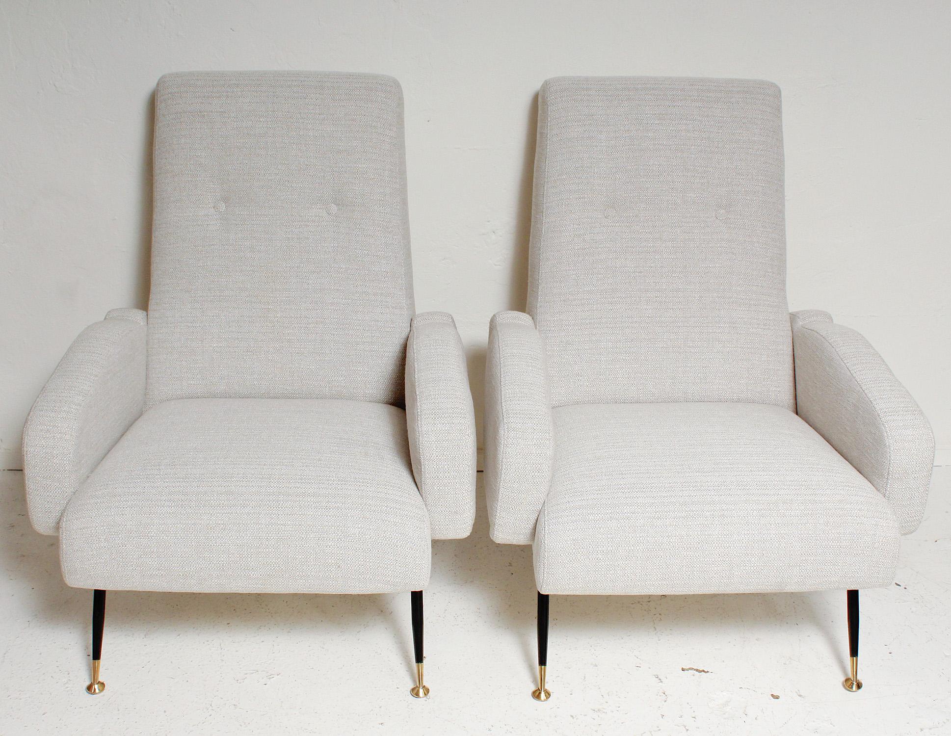 Oh-so-sexy pair of 1950s Italian lounge chairs, fully restored with all new foam, palest grey and cream upholstery, and freshly polished brass details.