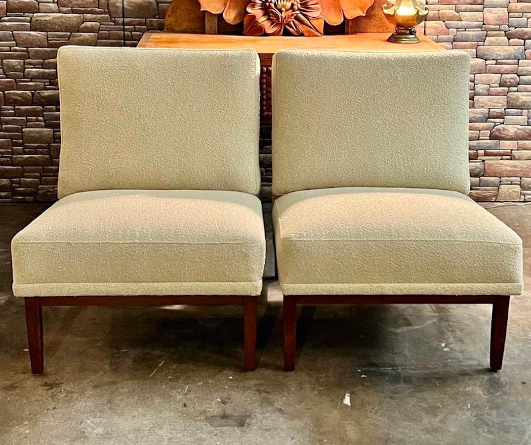 Pair of mid-century modern Florence Knoll for Knoll Associates lounge chairs, 51w is made of walnut and has been professionally reupholstered in a cream boucle. 

24