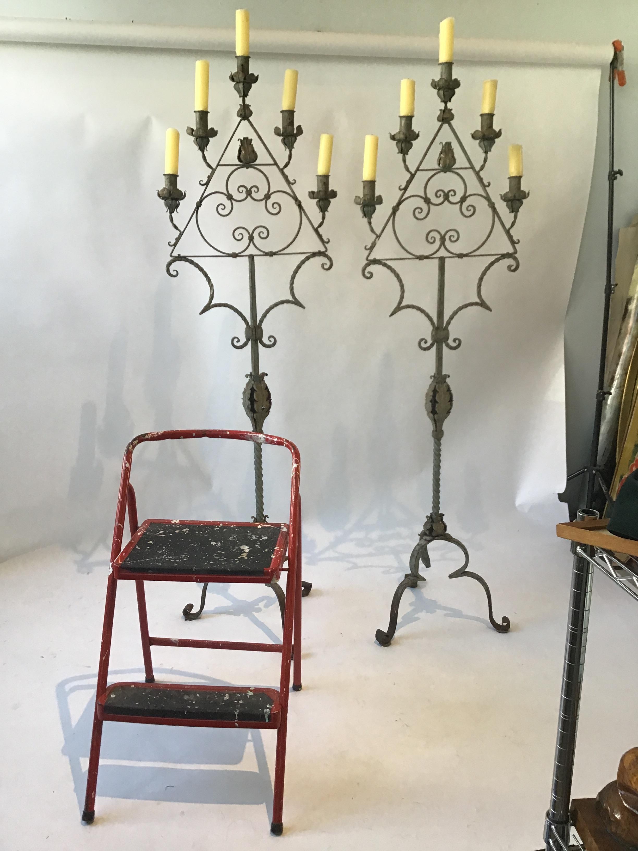 Pair of almost 6‘ high 1920s wrought iron candelabras from a Southampton, NY estate.