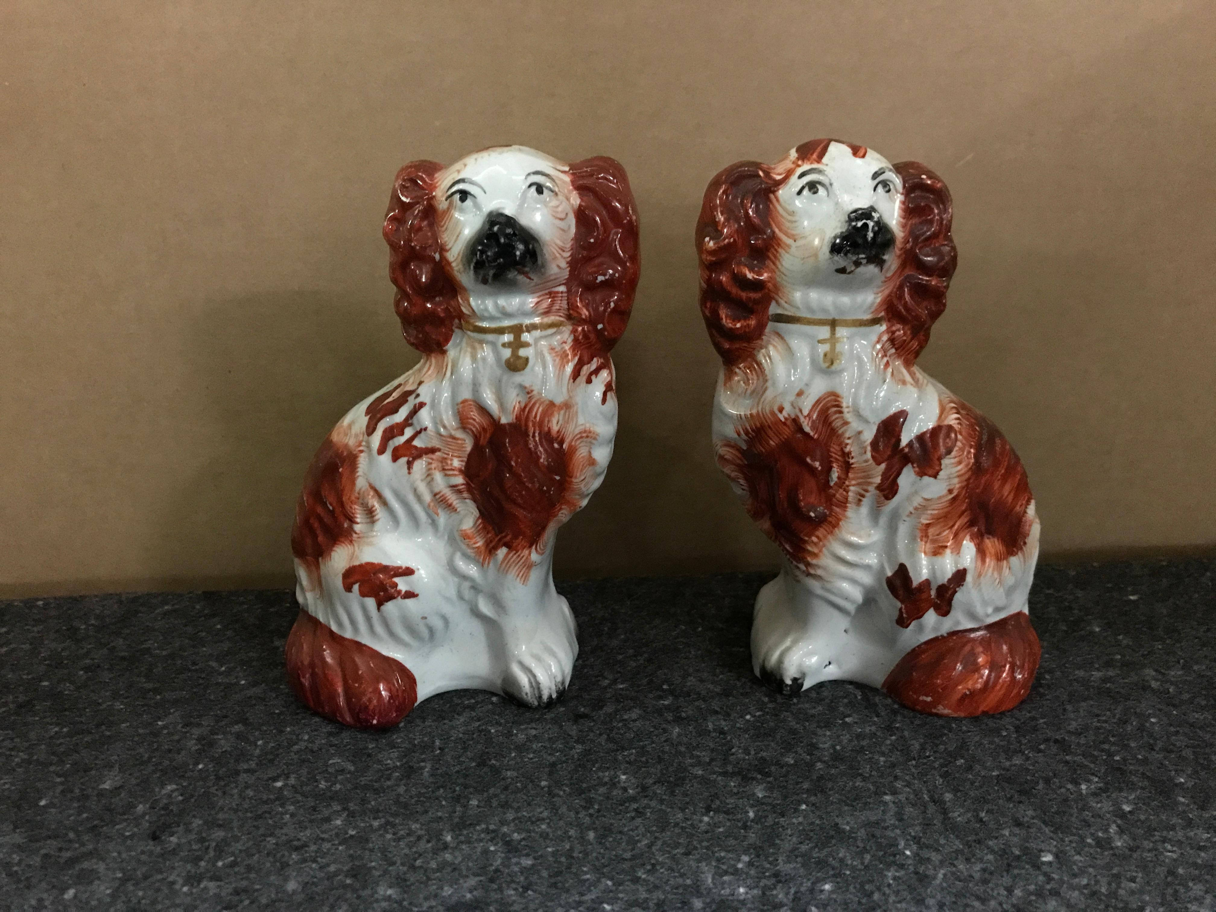 Pair of #6 Staffordshire England red seated spaniel dogs, well painted with.
 