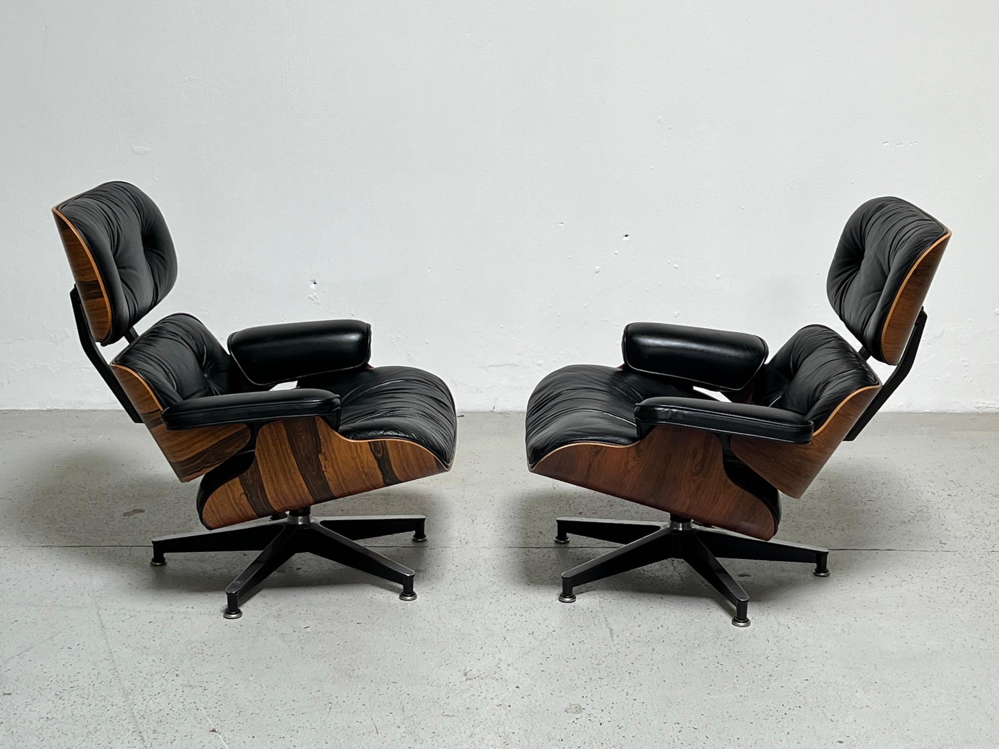 A pair of 670 lounge chairs designed by Charles Eames for Herman Miller in rosewood and original black leather. Both signed and dated 1978.