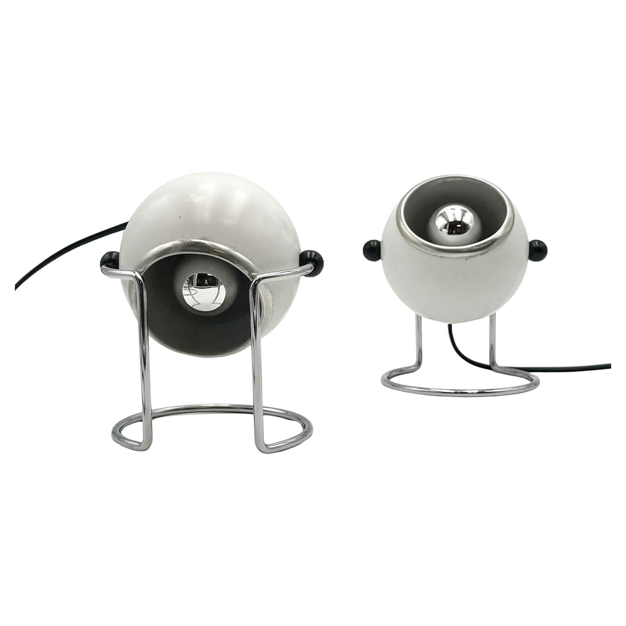 A refined example of space age lighting, this pair of vintage Targetti Sankey eyeball lamps offers both aesthetic appeal and practical functionality. 

Their distinctive 360° rotating shades provide adjustable illumination, while the restored warm