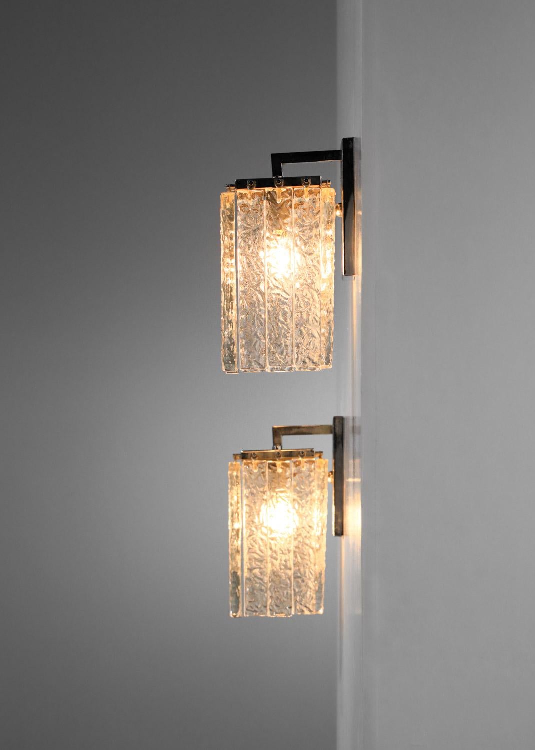 Pair of Italian sconces from the '70s. Chromed steel structure and rectangular clear Murano glass pendants. Beautiful vintage condition with traces of age on metal parts (see photos). Original electrical system, one E14 LED bulb per sconce. 