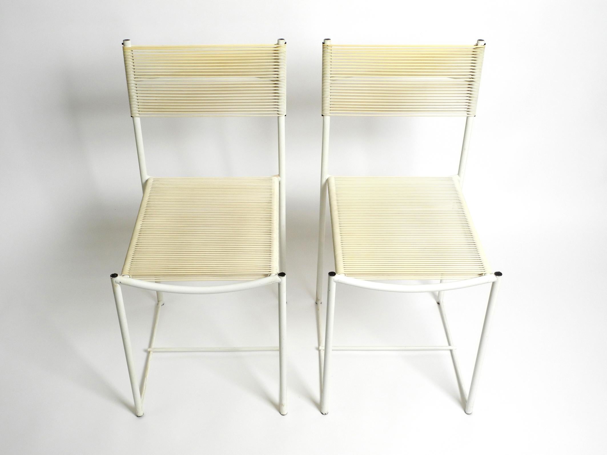 Pair of 70's original Spagetti chairs in white by Giandomenico Belotti. Manufacturer is Alias. Made in Italy. Rare in white lacquered frame and white seats + backrests. Beautiful minimalist Italian design of the Pop Art era. In good condition with