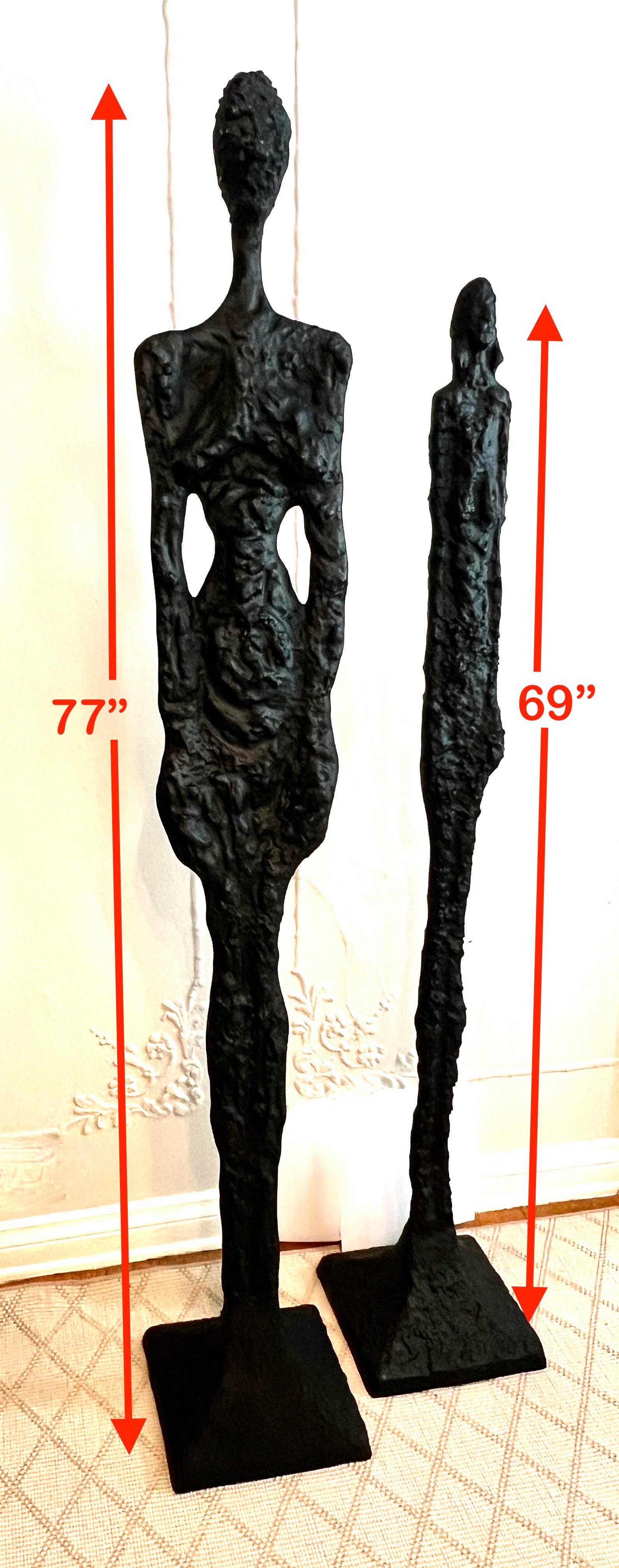 A pair of cast metal Sculptures, male and female.  The finish is newly finished in black.

The pair are heavy and substantial, but we do not believe them to be Bronze.   They do make a great statement as a pair, however we may consider selling them