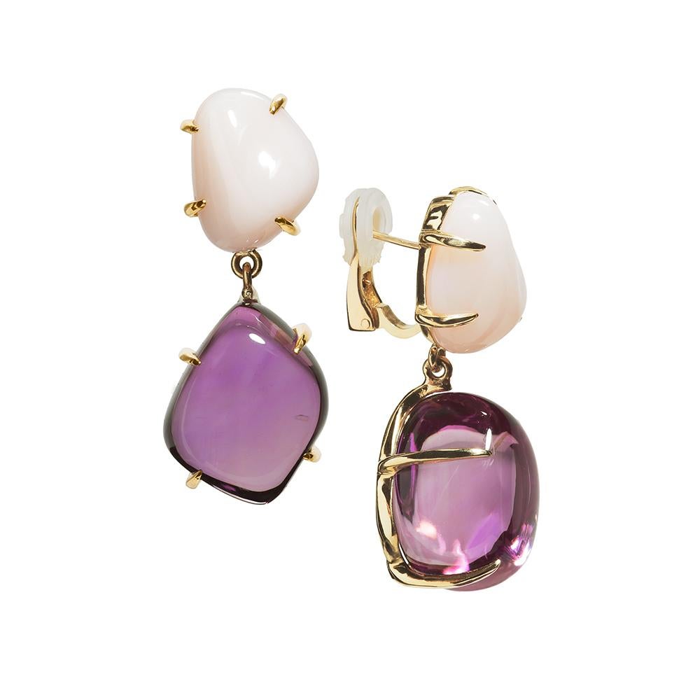 These one-of-a-kind, handcrafted earrings featuring natural organic shape Amethyst suspended by opaque Pink Opal set in 18 karat yellow gold.
-77.90 carat t.w. Amethyst
-21.50 carat t.w. Peruvian Pink Opal
-18 karat Yellow Gold