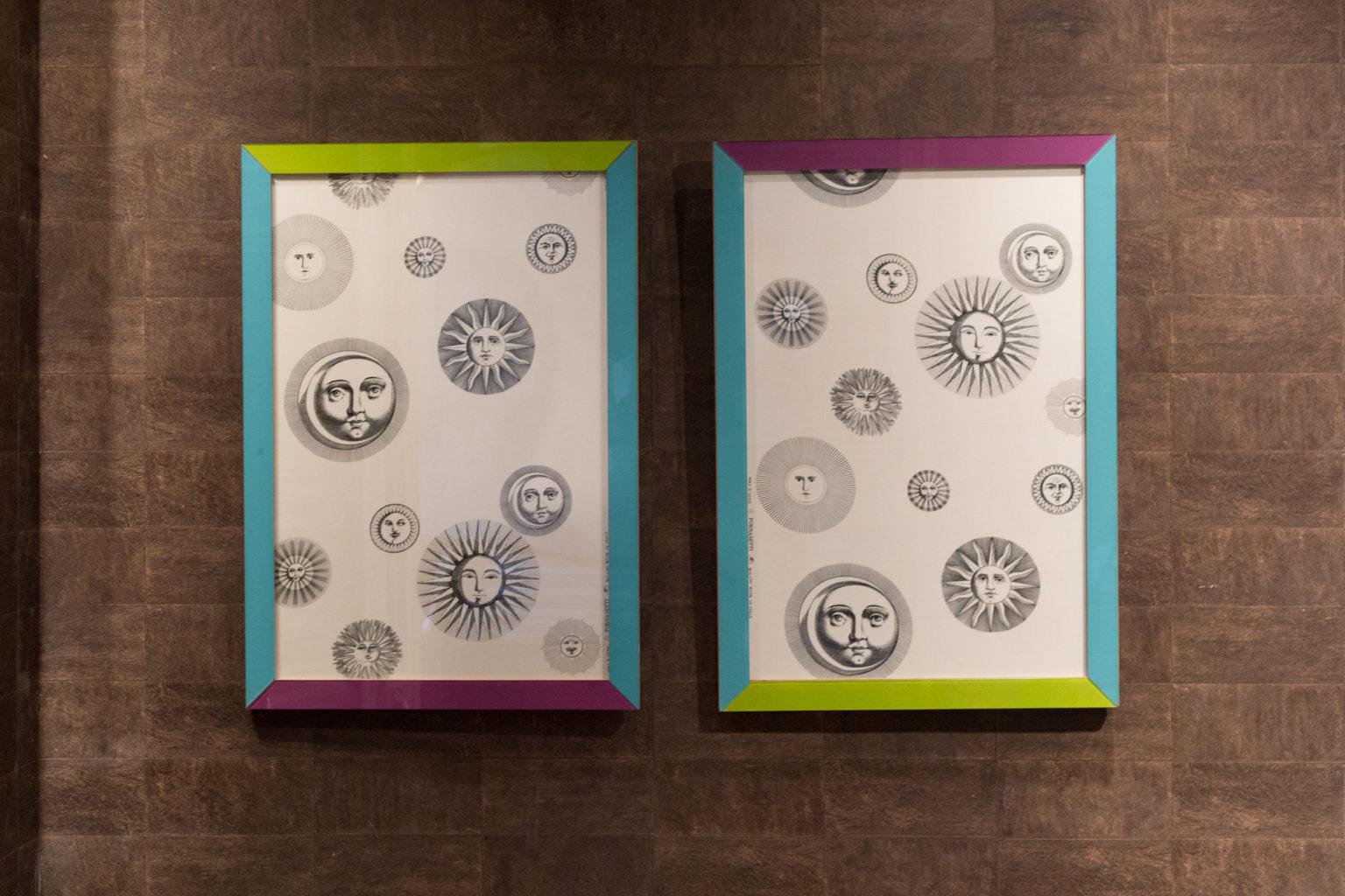 This pair of highly decorative panels features an original cotton sateen textile designed by Piero Fornasetti, with the motif of his “Soli e Lune” series.
The gorgeous original frames are colored glass on wood.
On both panels, the fabric,