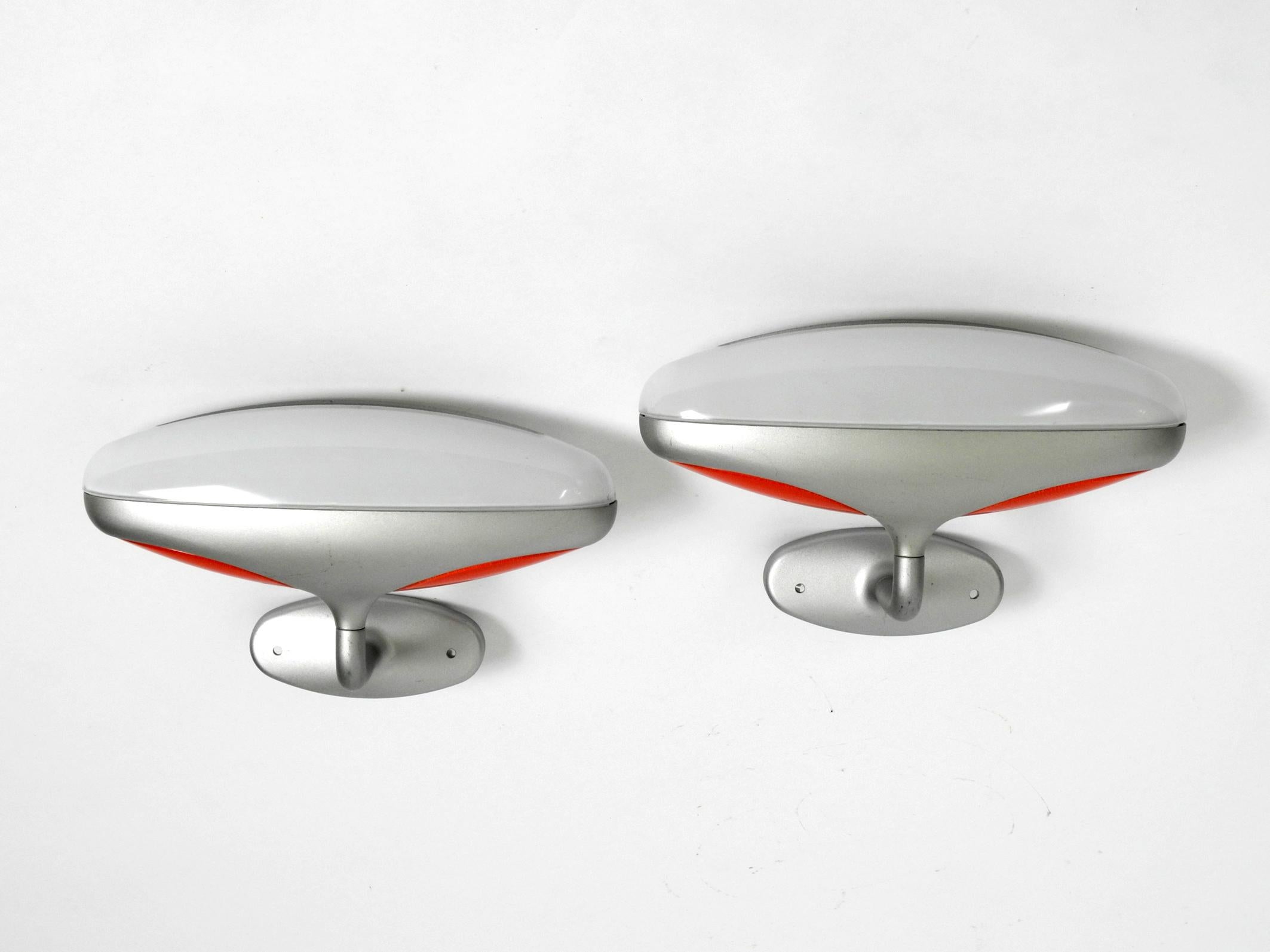 Pair of very rare 1980s metal glass wall lights.
Great Postmodern design from Candle. Gruppo Fontana Arte. Made in Italy. 
Powder-coated metal frame. Lamp consists of a long white glass on top with a slit, 
because of the heat, and two red