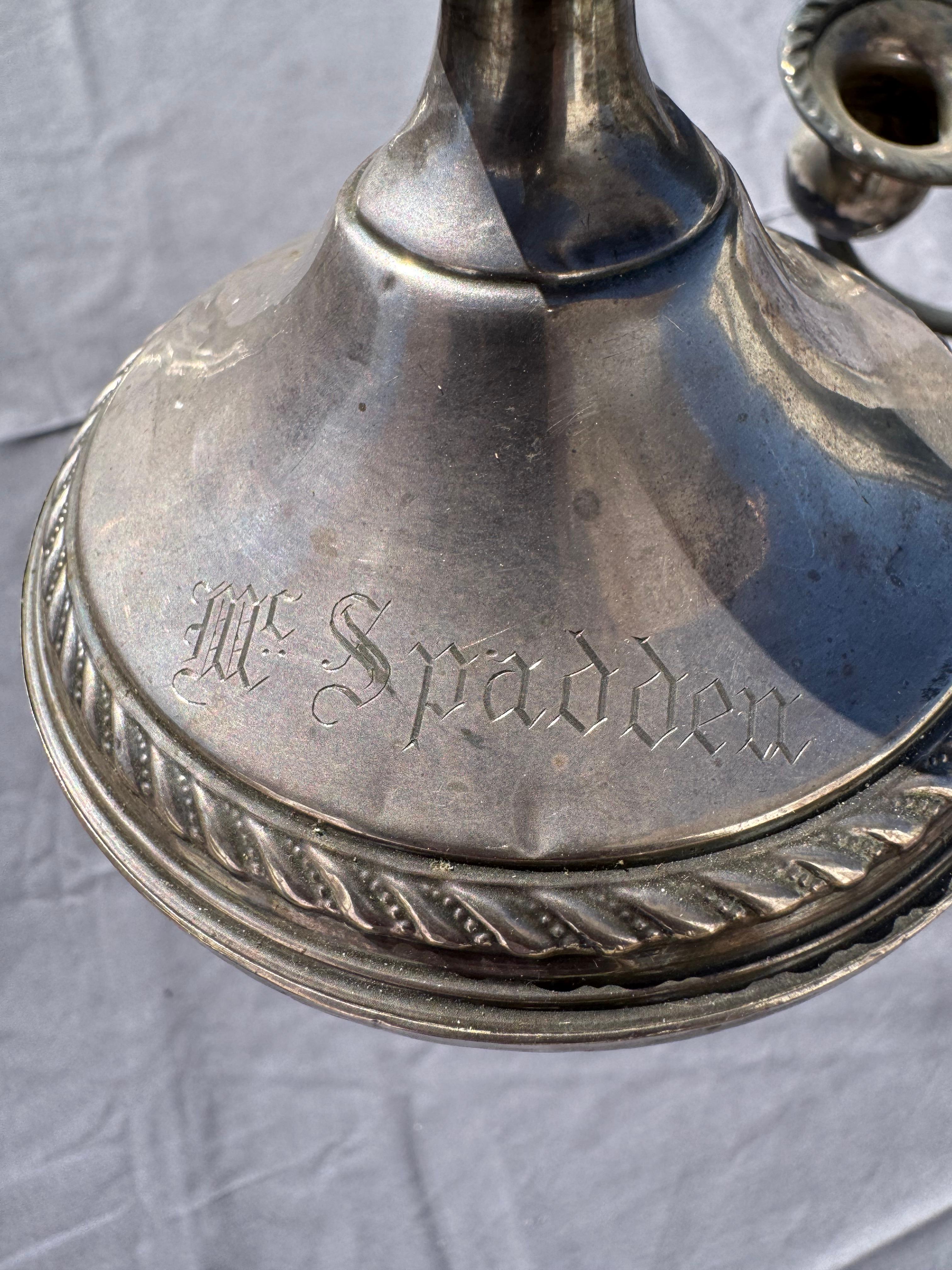 These candelabras are sterling weighted.
There are 3 candleholders on each.
The rims are rope edged and they're etched McSpadden.

The lower neck on one is damaged and dinged.