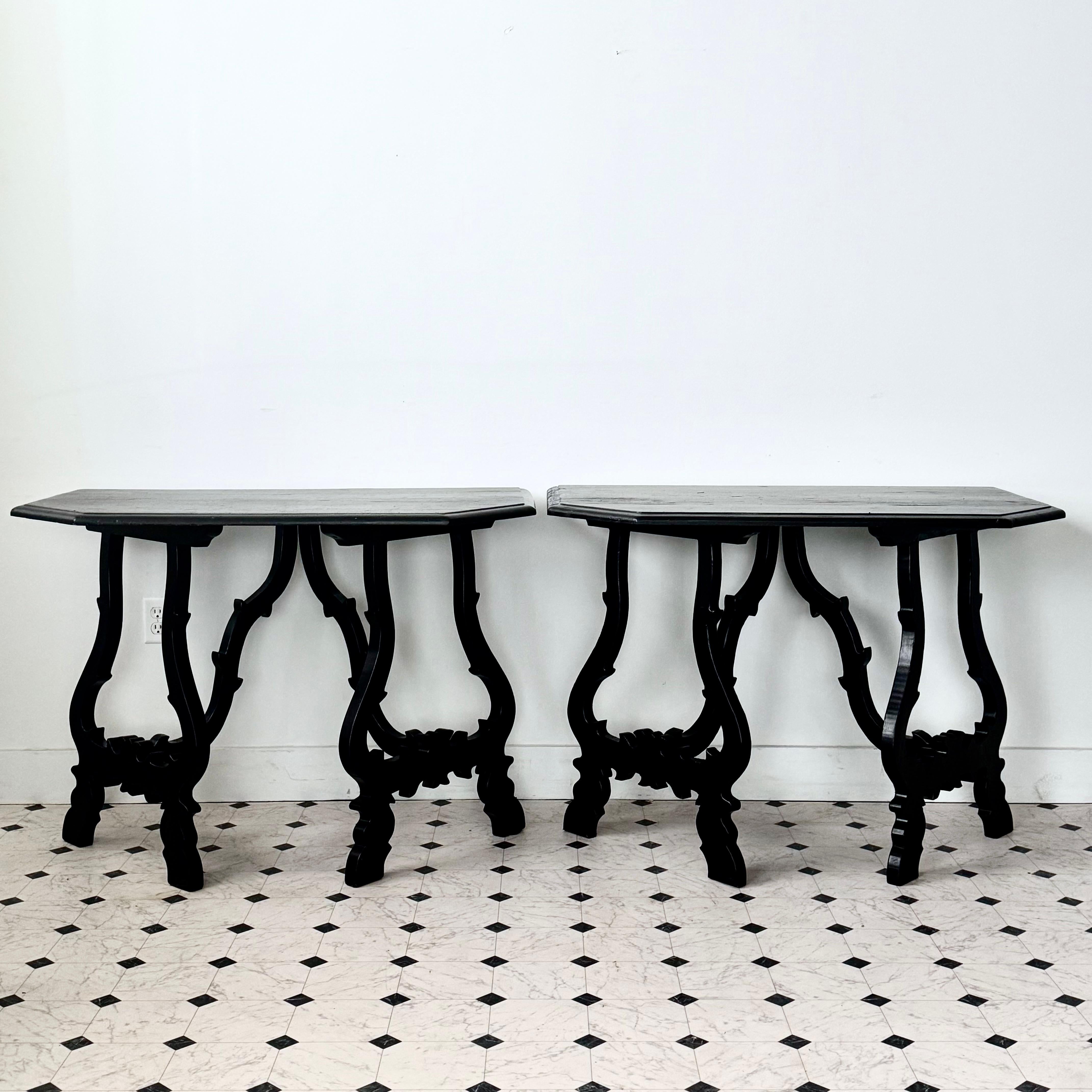 Italian 19th century pair console tables with cut corner tops on a pair of carved and canted lyre legs and sculpted wooden stretchers .
All in black finish.
Toscana, Italy