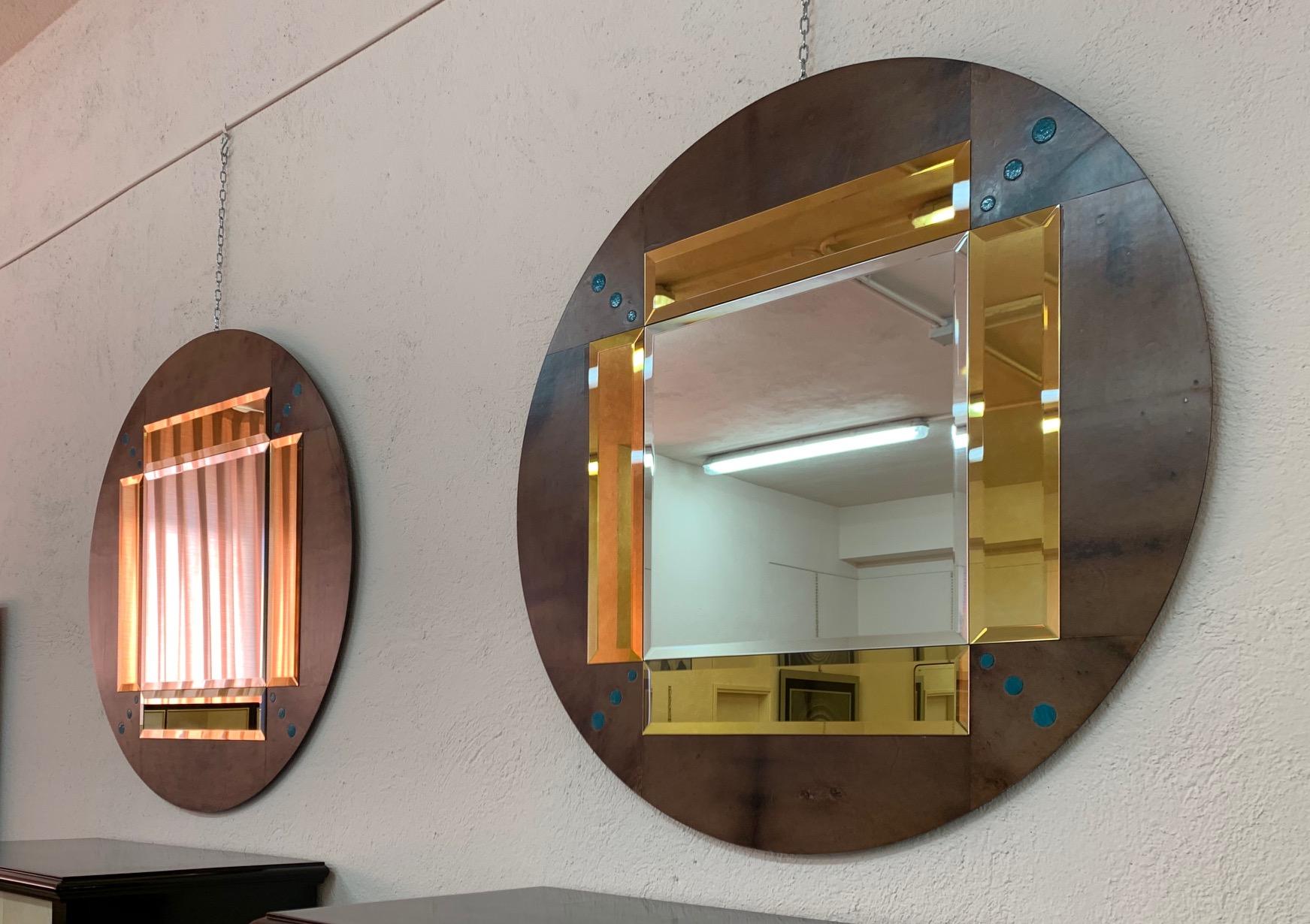Fine pair of mirrors produced in Italy by master craftsmen.
The frame is covered in goatskin with blue Shagreen inlays.
The side mirrors are bevelled and gold colored.

Can be ordered in other combinations of finishings and sizes.