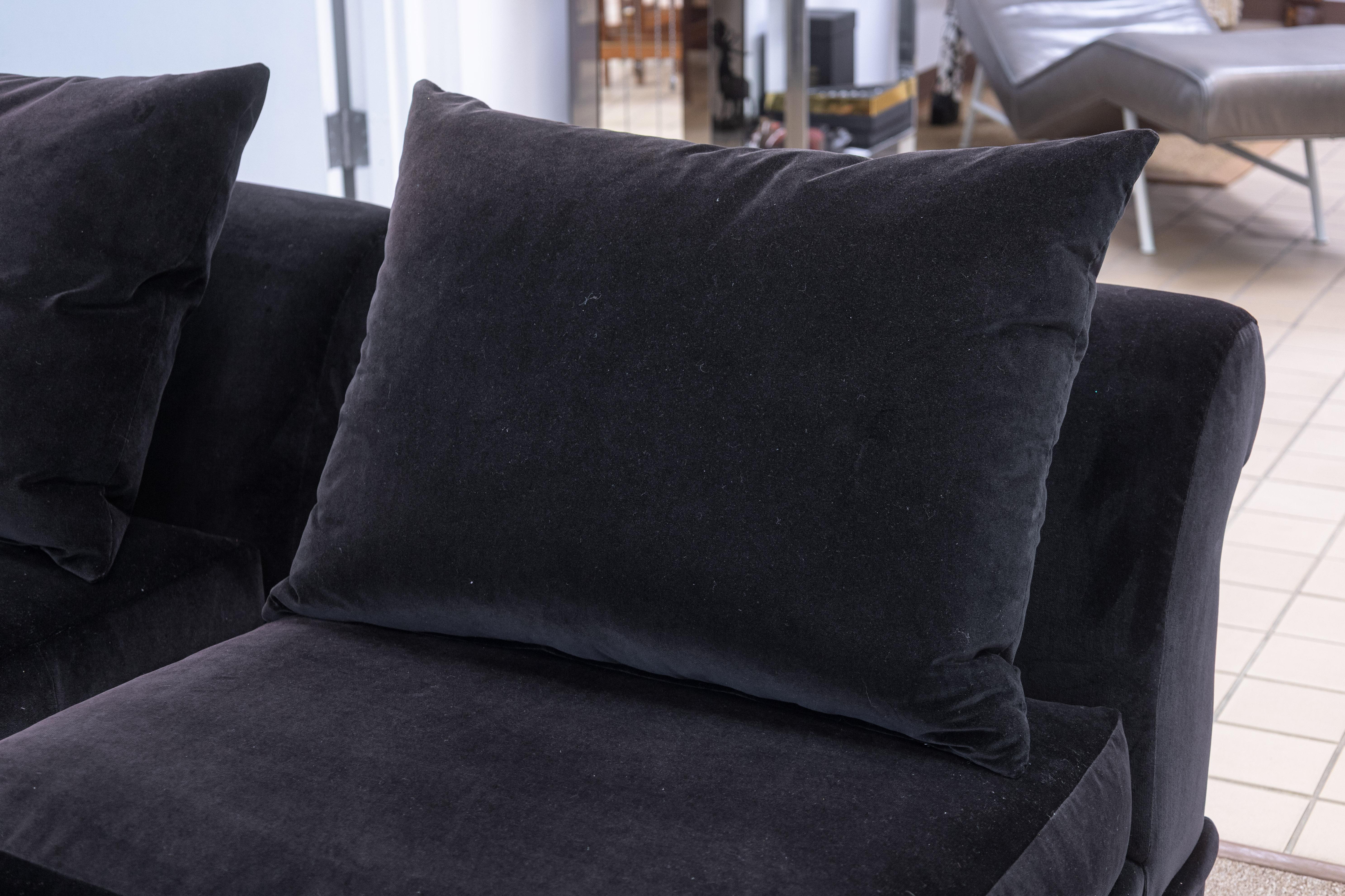 A pair of A. Rudin custom made velvet slipper chairs. This lovely set of accent chairs arm produced by Los Angeles-base custom furniture company A. Rudin. Each chair is constructed with a strong wooden frame, and upholstered in a gorgeous deep plum