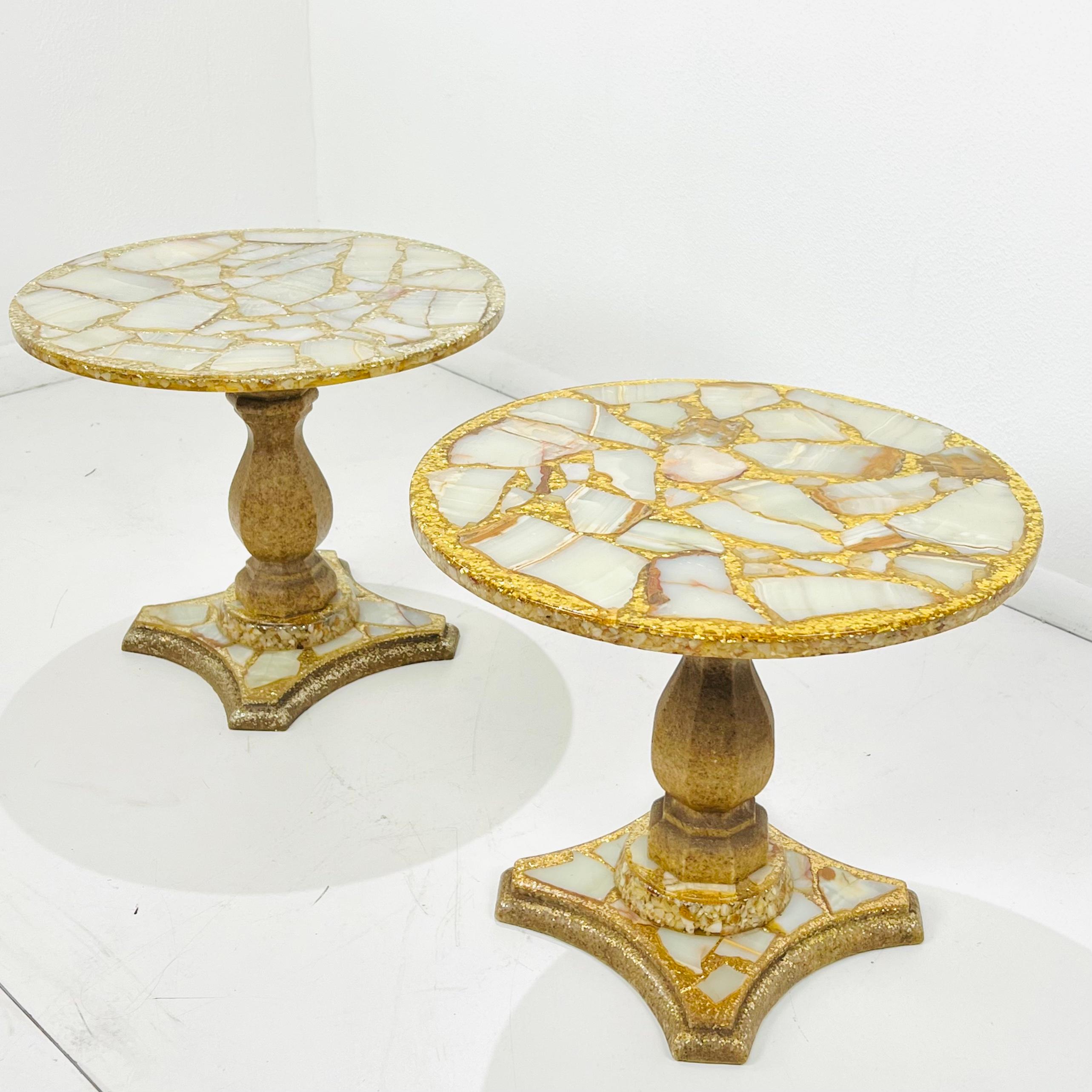 Designed by famous Mexican artist, Arturo Pani (1915-1981), this chic pair of side or end tables features cross sections of cream and copper colored onyx stone floating in a sea of gold leaf glitter and abalone shells cast in resin. Crafted in