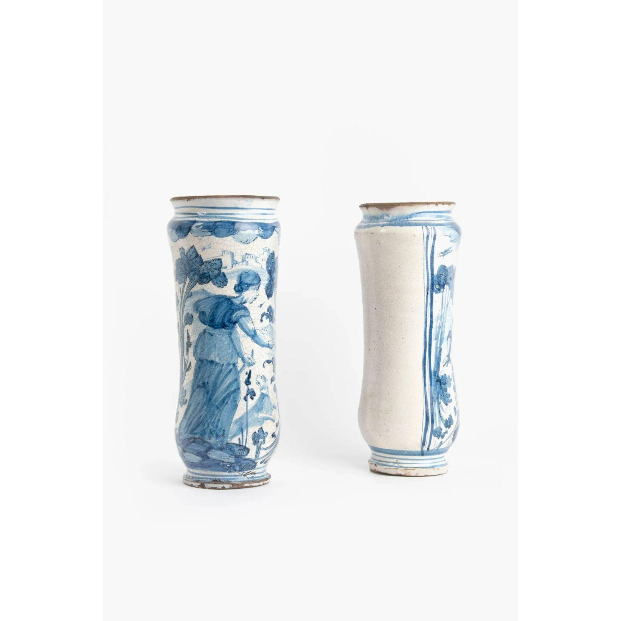 17th Century pair of Abruzzo Maiolica Albarelli

Waisted cylindrical form decorated with classical figures. White tin glaze with blue decoration.

Dimensions: 29 x 12 cm.