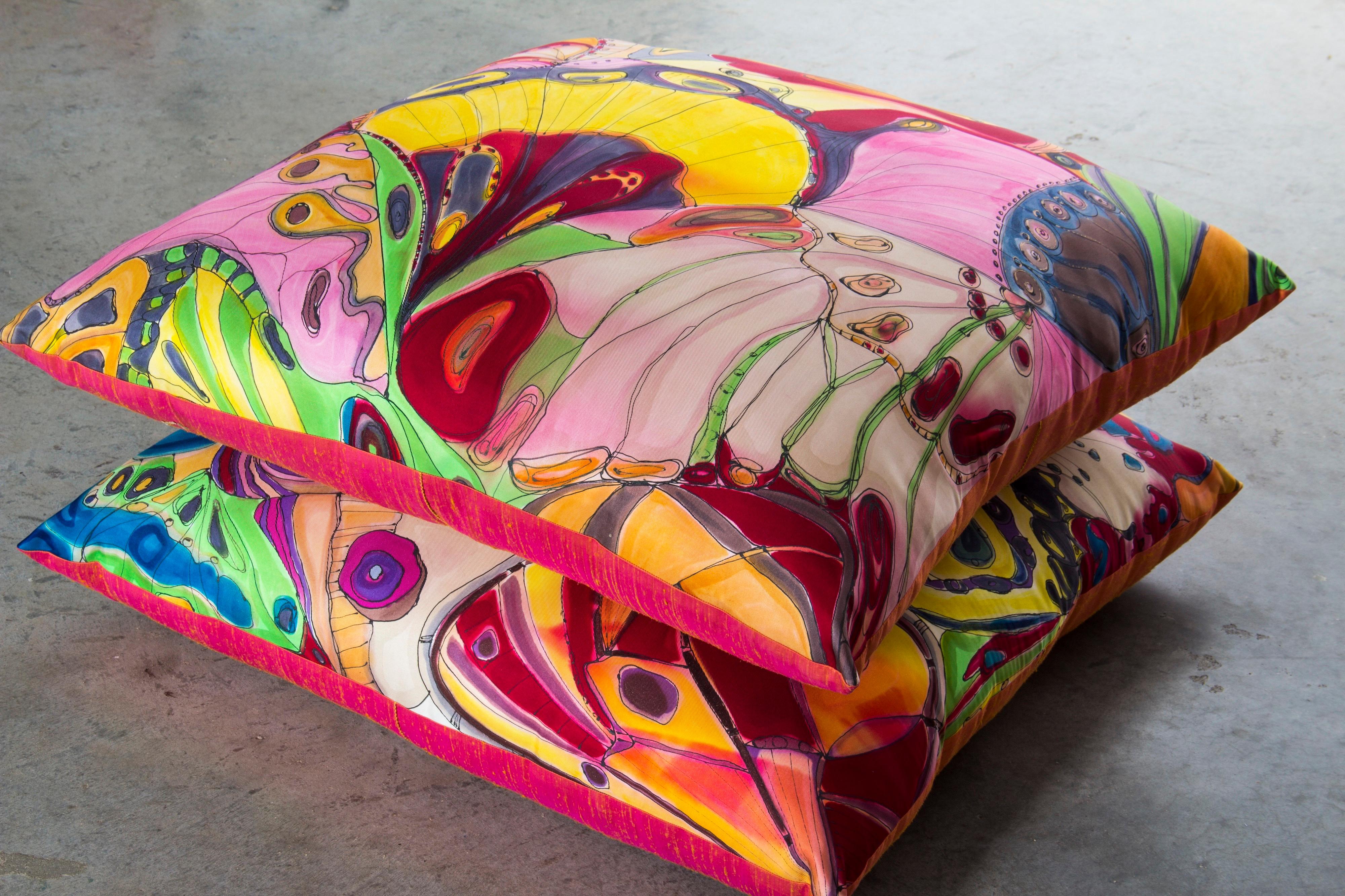 A pair of abstract hand painted silk butterfly & caterpillar floor pillows. Handmade floor pillows made from hand painted silk by Chicago designer Terrance Michael. Design is abstract with a myriad of colors. One of a kind, impeccable