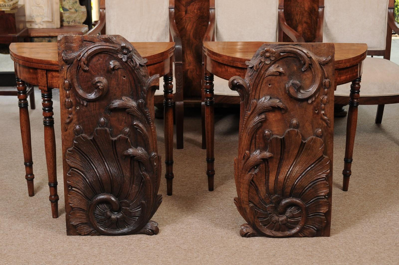 A pair of architectural elements with beautiful acanthus leaf and flower carving. The elements are constructed out of walnut with rich patina from the 18th century and quality detailed carving.