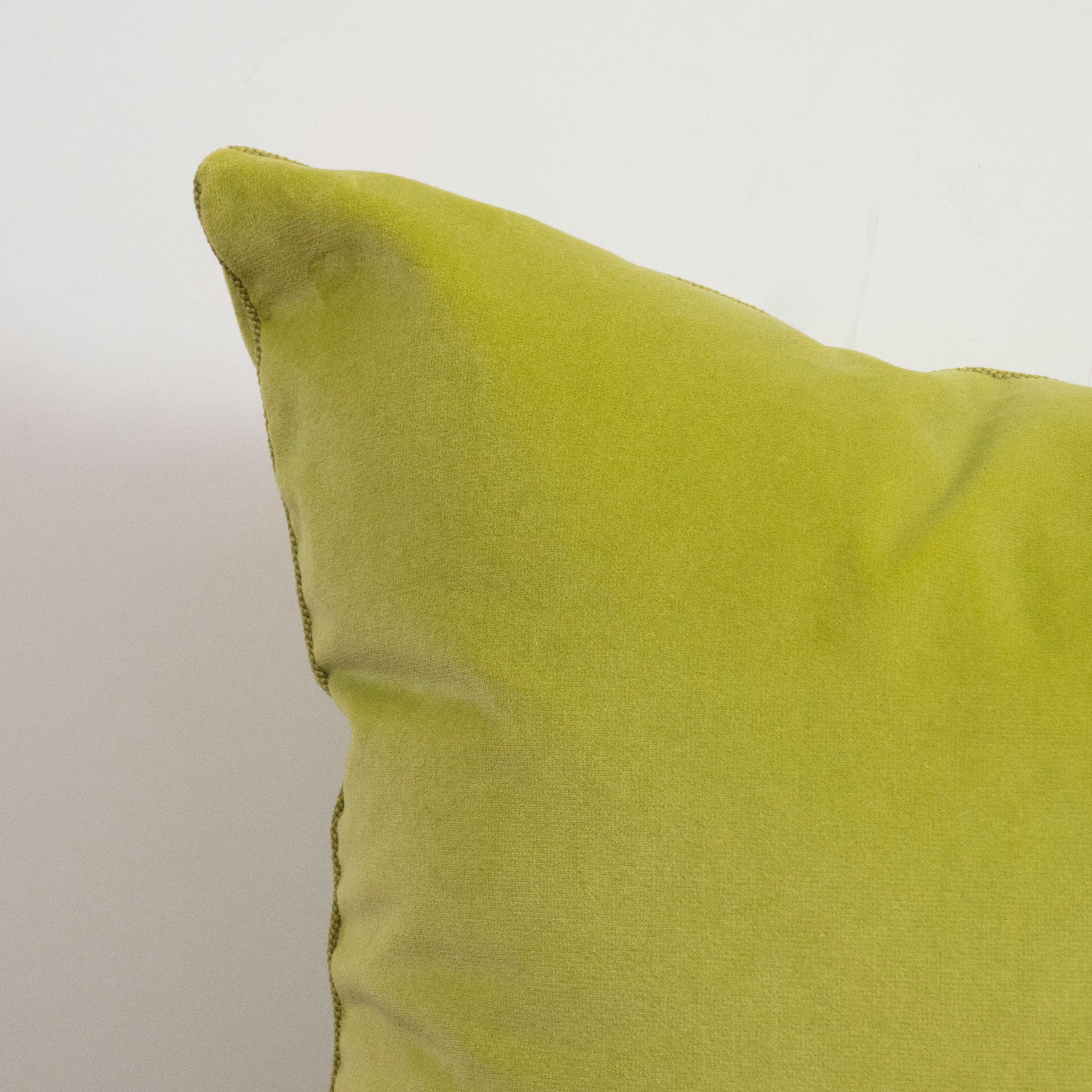 A pair of knife-edged square pillows in a fabulous acid green velvet.