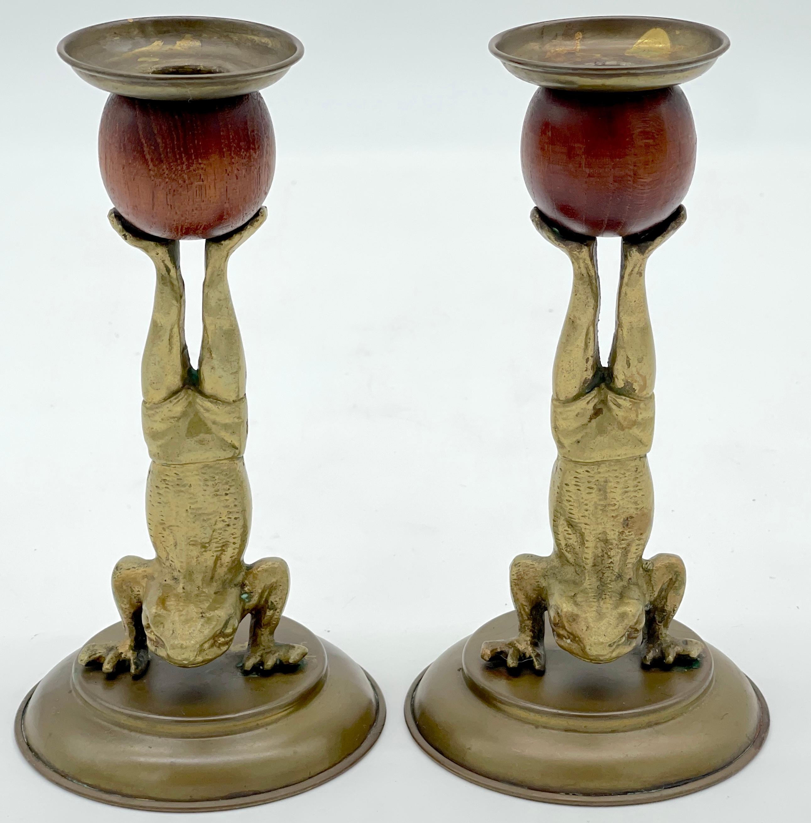 A Pair of Acrobatic Frog Brass & Wood Candlesticks by Arthur Court, 1979 

Add a whimsical touch to your interior, consider this charming pair of acrobatic frog brass & wood candlesticks by Arthur Court.  Each Victorian-style candlestick stands at 7