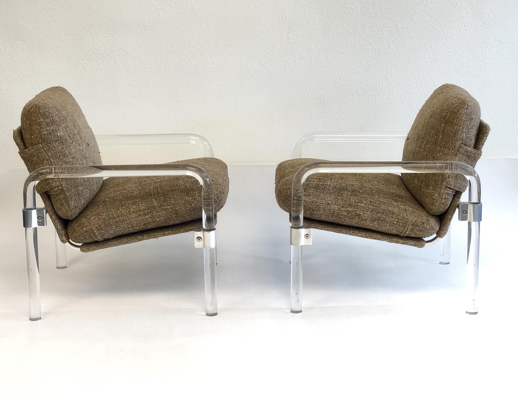A glamorous pair of clear acrylic and polish chrome “Pipe Line Series 2” lounge chairs by Jeff Messerschmidt. Both chairs are signed, numbered(#162, #163) and dated 1982.
The chairs retain original light brown fabric upholstered by a Palm Desert
