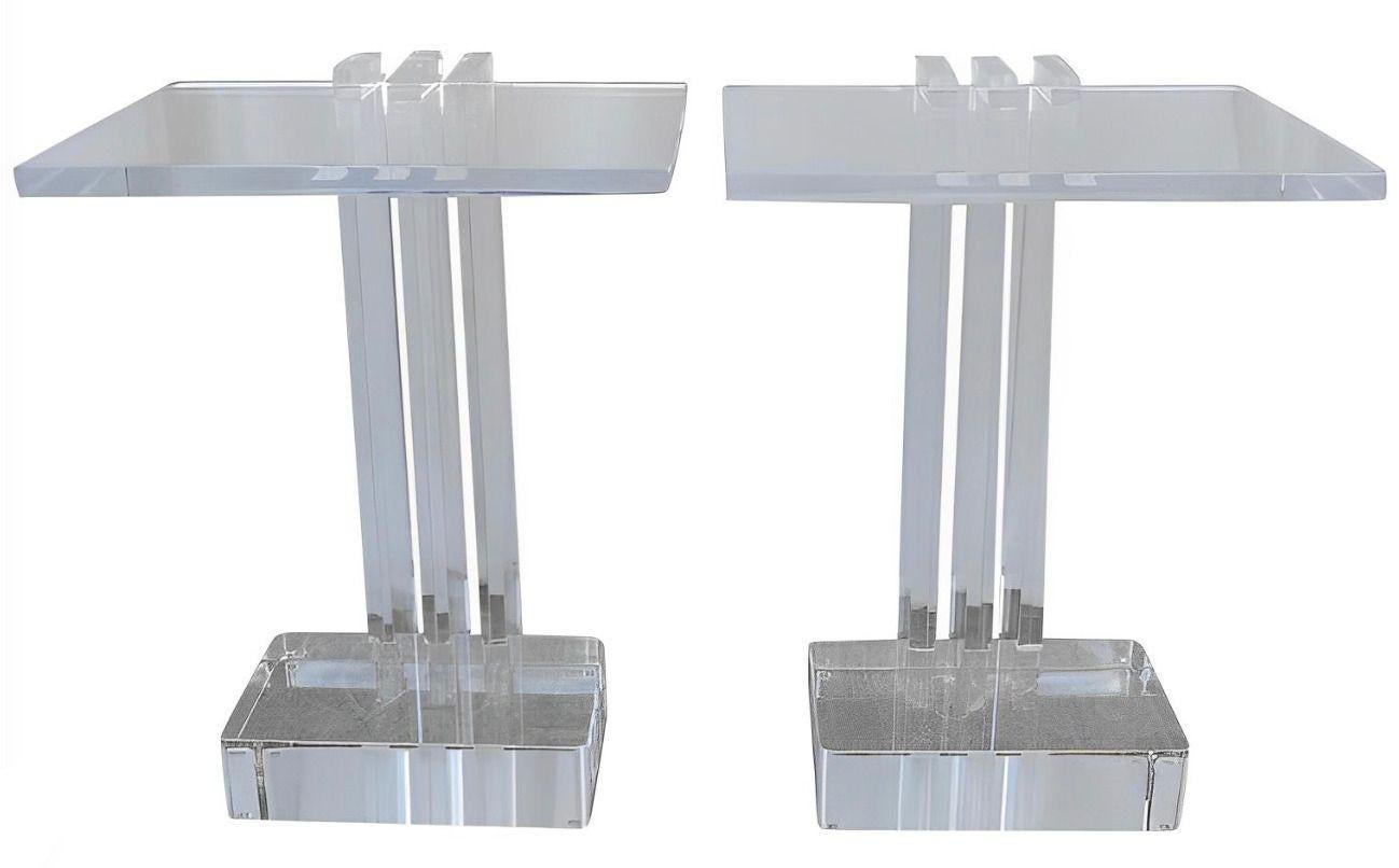 A sleek and sculptural pair of vintage acrylic side tables by Les Prismatiques, crafted in the U.S.A during the 1970's. Each table features a minimalist design composed entirely of clear, high-quality acrylic, with a substantial 1-inch thick top and