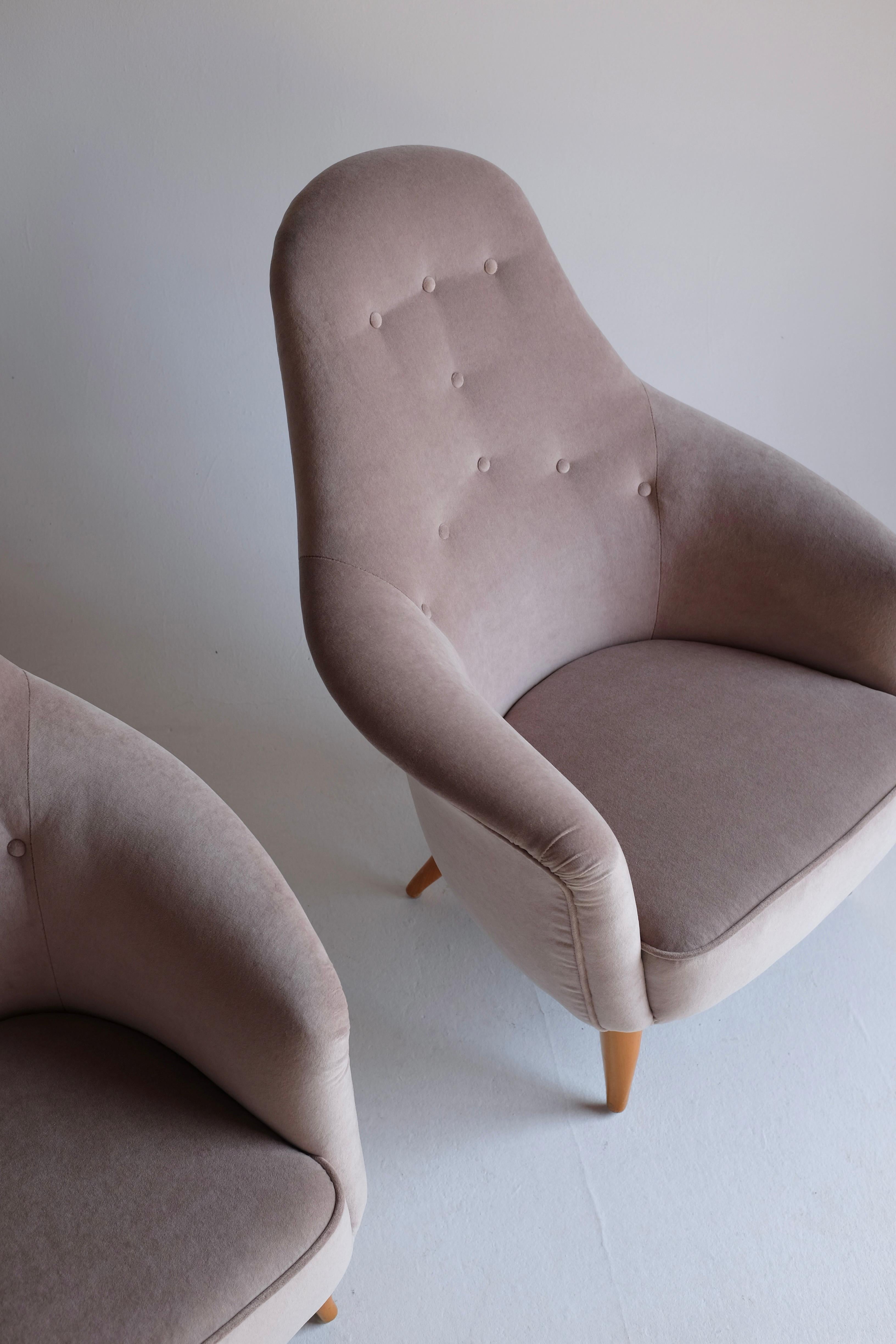 Pair of Adam Lounge Chairs by Kerstin Hörlin-Holmquist, created in the mid 1950's for Nordiska Kompaniet and part of the Paradiset collection. This Swedish mid-century icon bears her signature look of a light and gracious design. Newly upholstered
