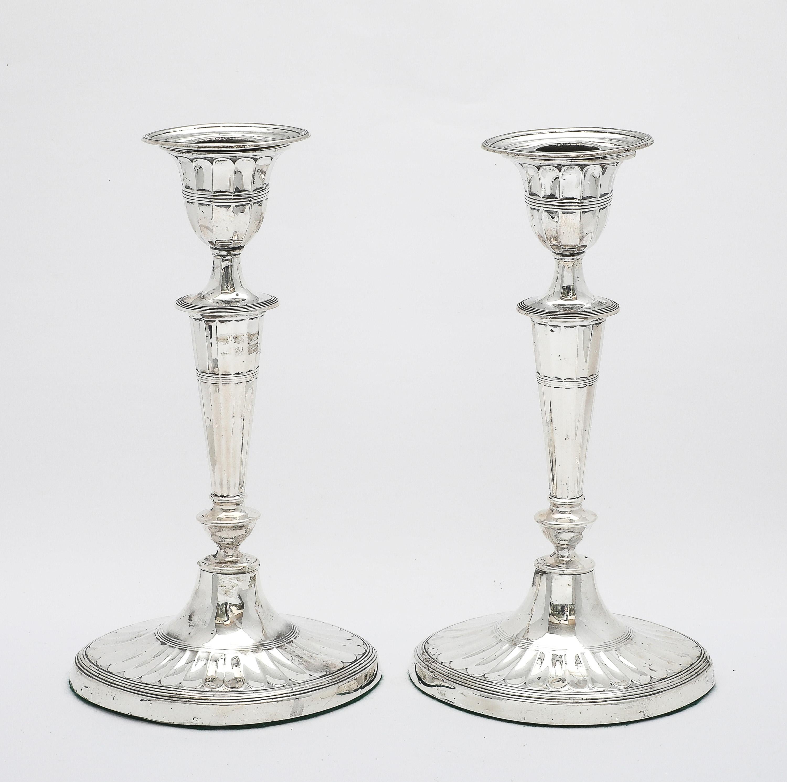 Pair of sterling silver, Adam-Style candlesticks, made in the city of Sheffield, England, year-hallmarked for 1906, Hawkesworth, Eyre and Co. Ltd. - makers. Each candlestick measures 8 1/2 inches high x 4 3/4 inches wide (at widest point across oval