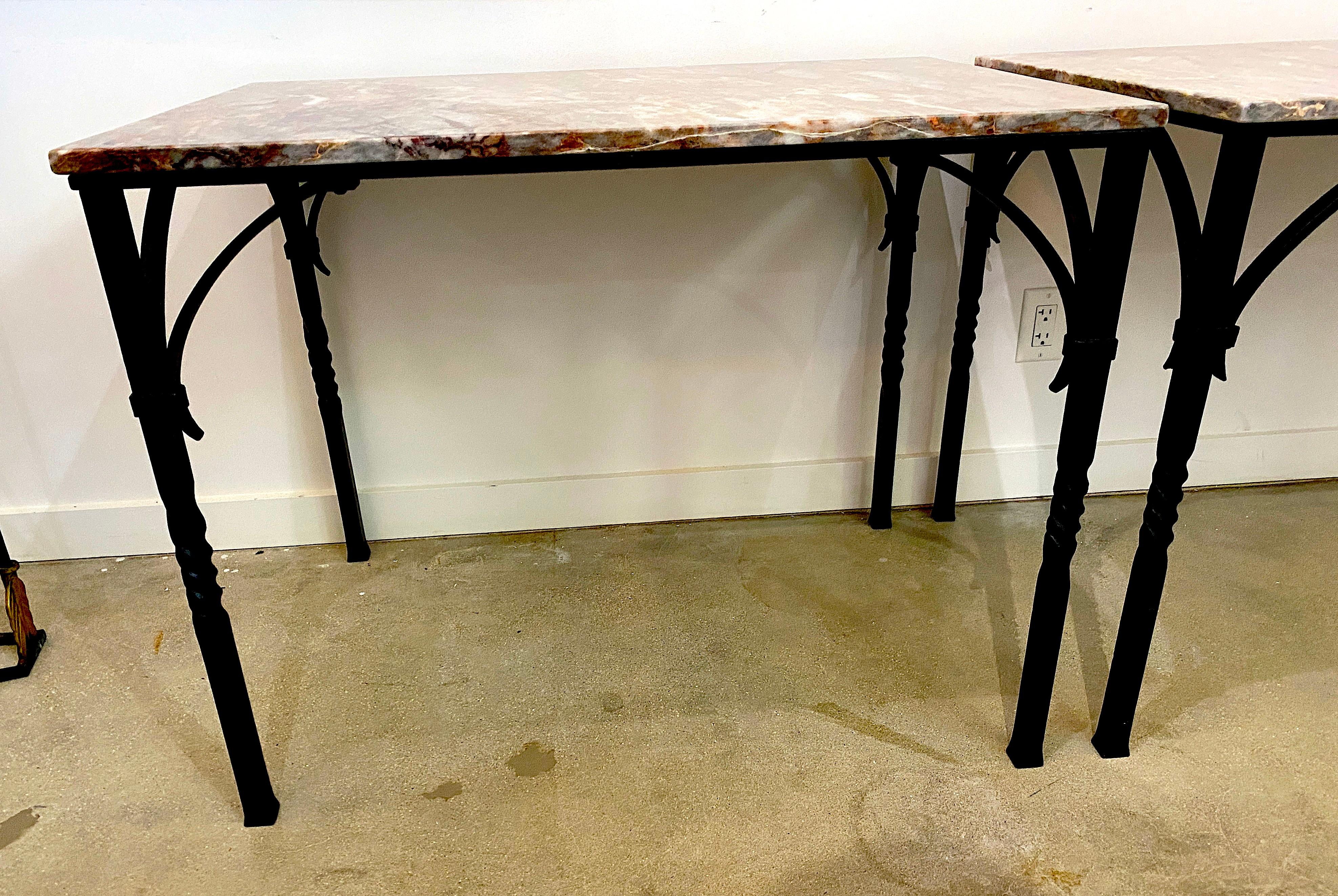 This stylish pair of wrought iron and marble console tables were created by Addison Mizner in the 1920s-1930s and they were acquired from a Palm Beach, Florida estate.

Note: The marble tops are a modern replacement.