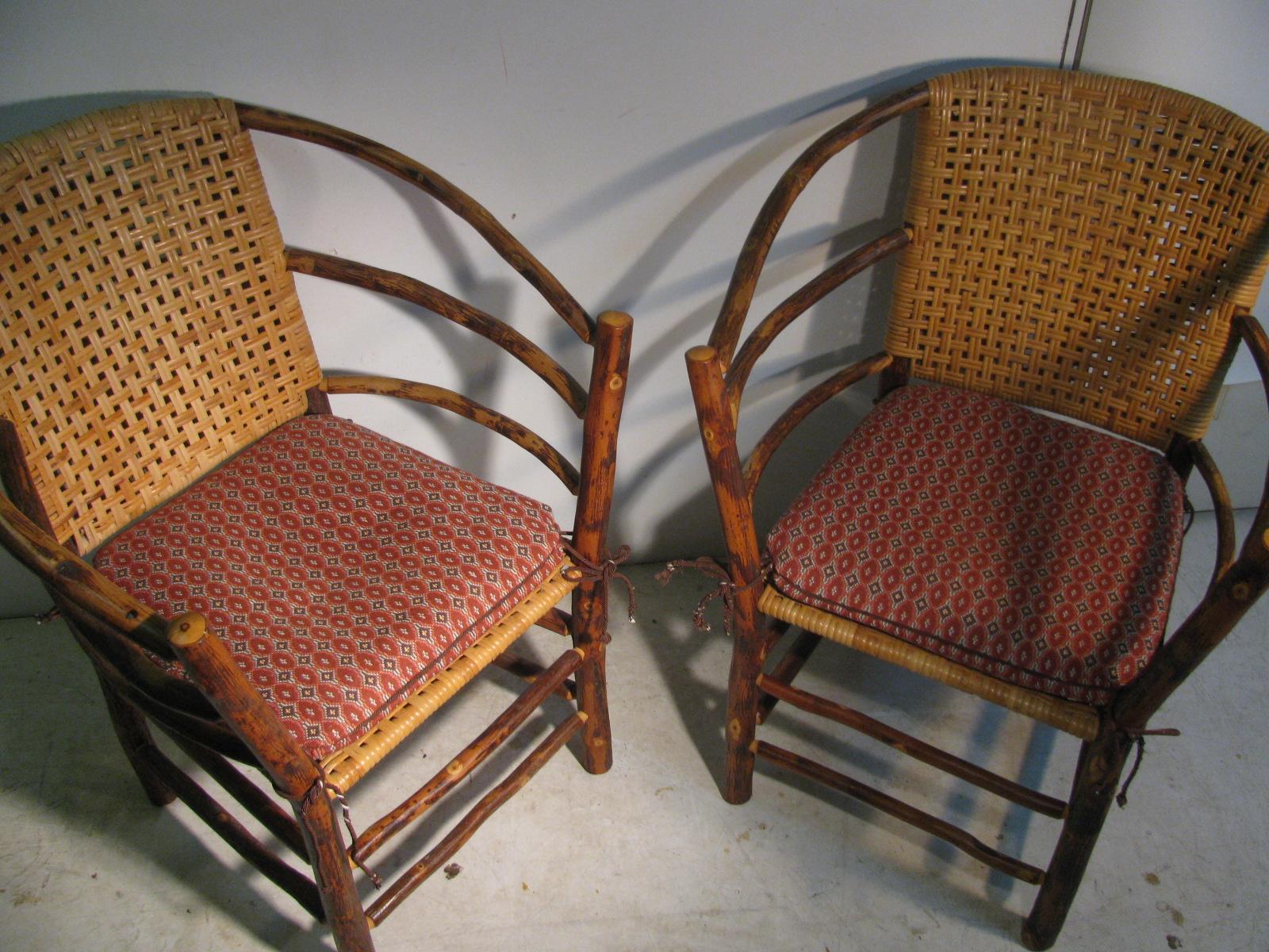Fabulous pair of old hickory indoor outdoor lounge chairs with split reed backs and seats. Cushions for the chairs are supplied as pictured. Chairs are not old and have virtually no wear to speak of. Unsigned but do have brass metal tags with