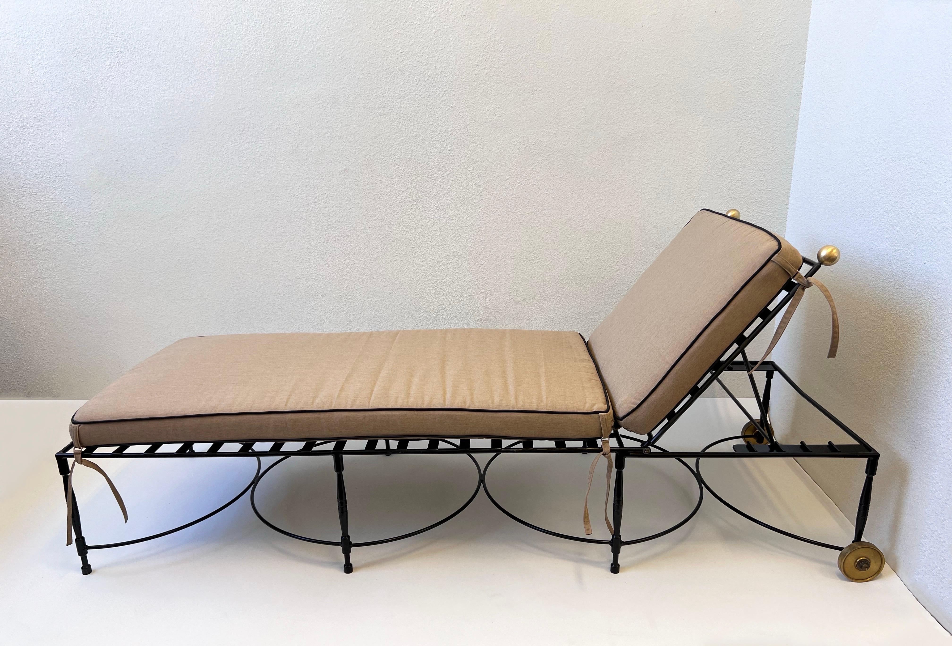 Rare pair of 1950’s adjustable outdoor lounge chaises designed by Italian designer Mario Papperzini for Salterini. 

Constructed of black powder coated iron and satin brass, with new dark khaki and black Sunbrella cushions. 
In beautiful condition