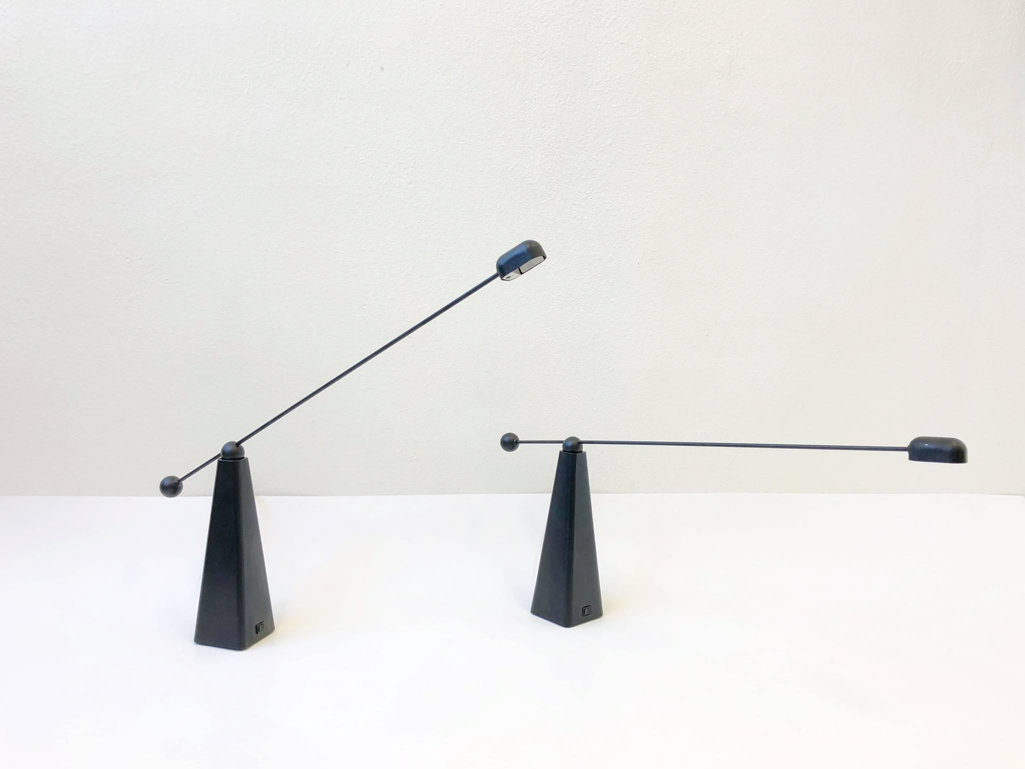 An amazing pair of 1980s black lacquered adjustable table lamps by Ron Rezek.
The lamps are in amazing condition. They have a high/low dimmer and take a small 50w halogen bulb. The arm rotates 360, and move up and down.

Dimension: 32” wide 4”