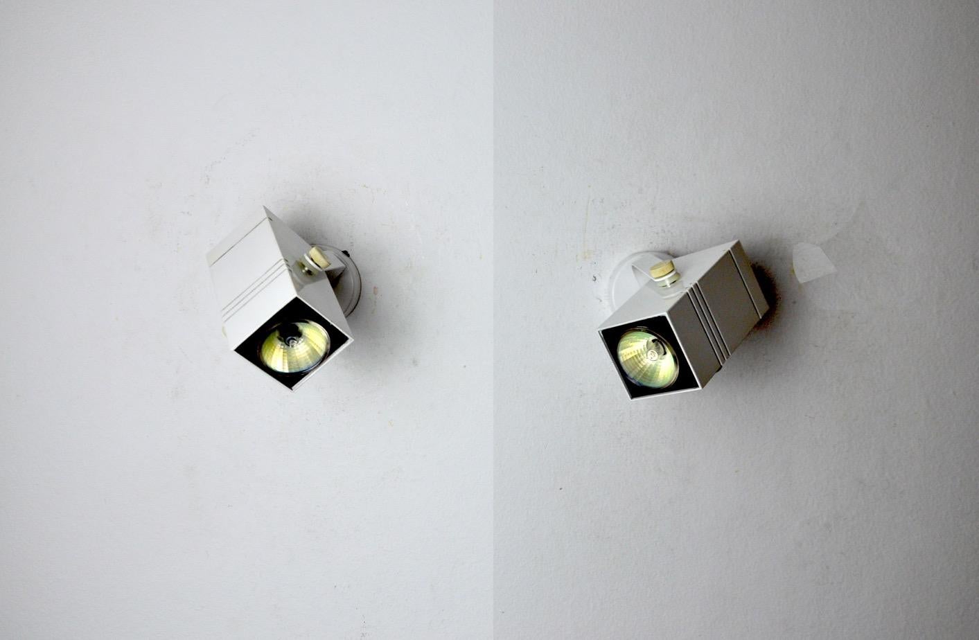 Very nice pair of fase wall lights designated and produced in Spain in the 80s. Rotating structure in white metal. Unique object that will illuminate wonderfully and bring a real design touch to your interior. Electricity checked, mark of time in
