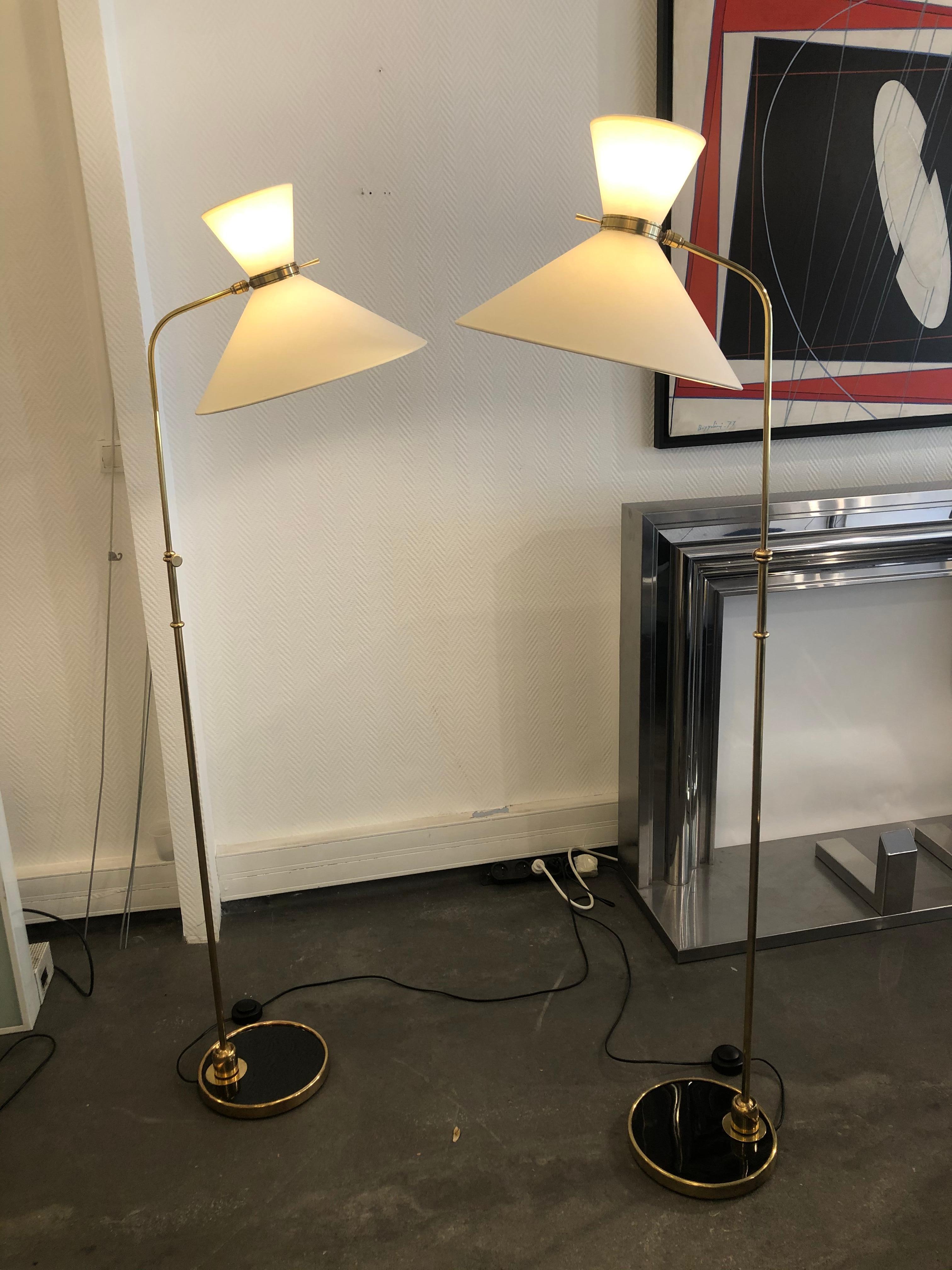 Pair of adjustable floor lamp by Maison Lunel 
from 1950
brass and black lacquered base
several possible positions thanks to these two ball joints.