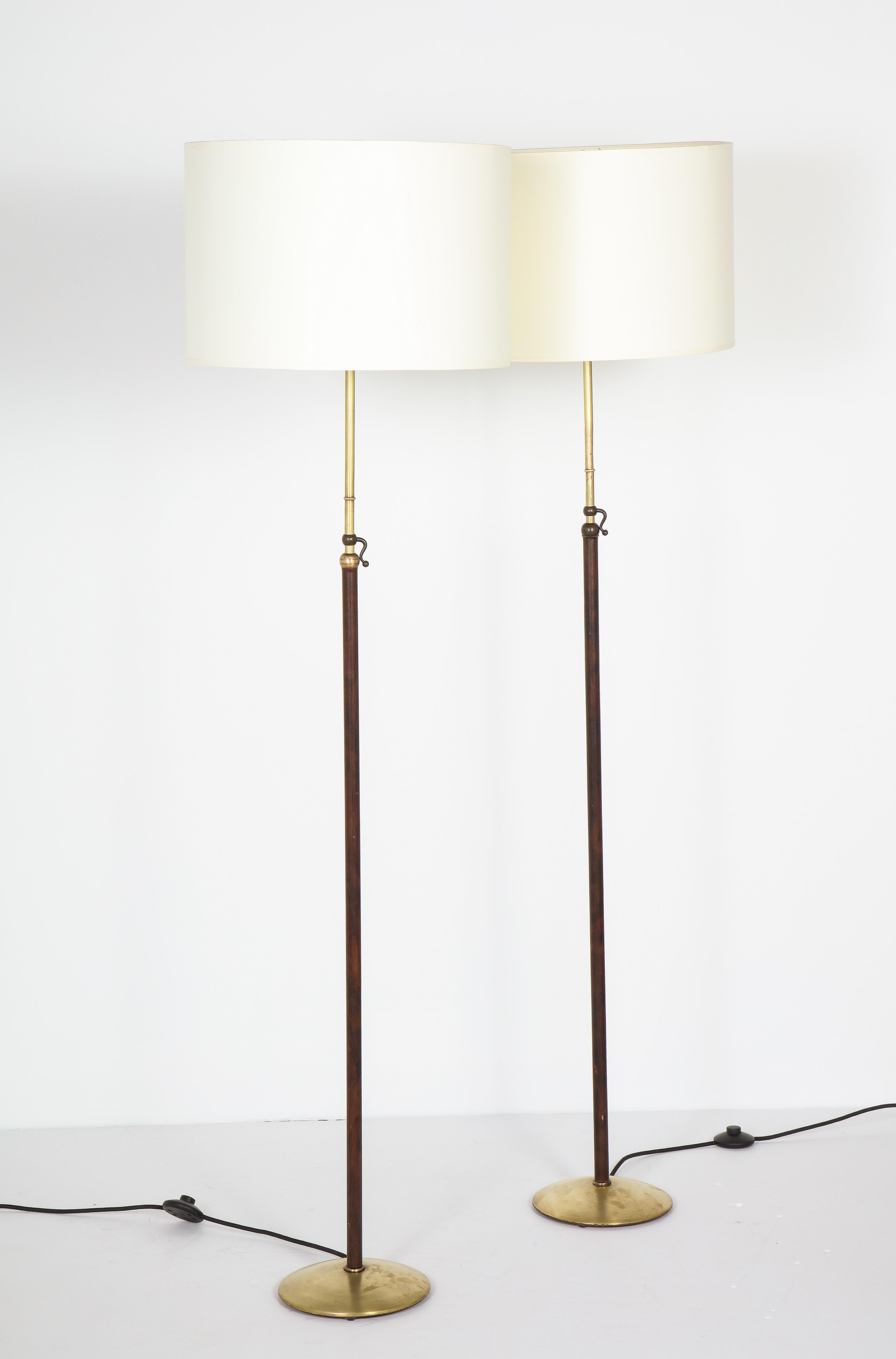 Patinated Pair of Adjustable Floor Lamps by Jacques Adnet For Sale