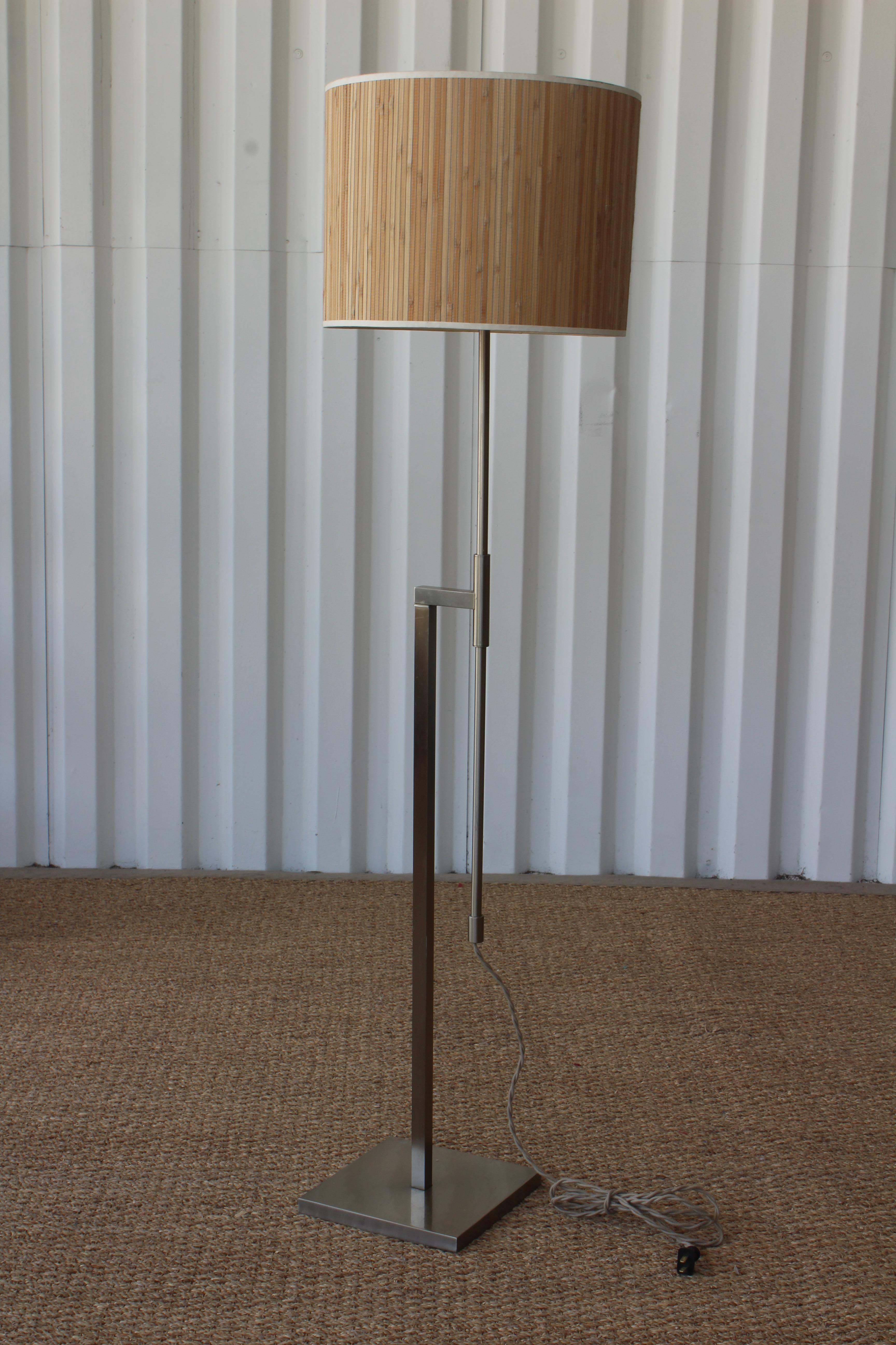Vintage height adjustable 1960s floor lamp by Laurel Lamp Company. Made of steel with original nickel plating. They have bamboo shades and have been rewired. There is some wear on each of the bases, please see detailed photos. One sold. 
Base is 8 x
