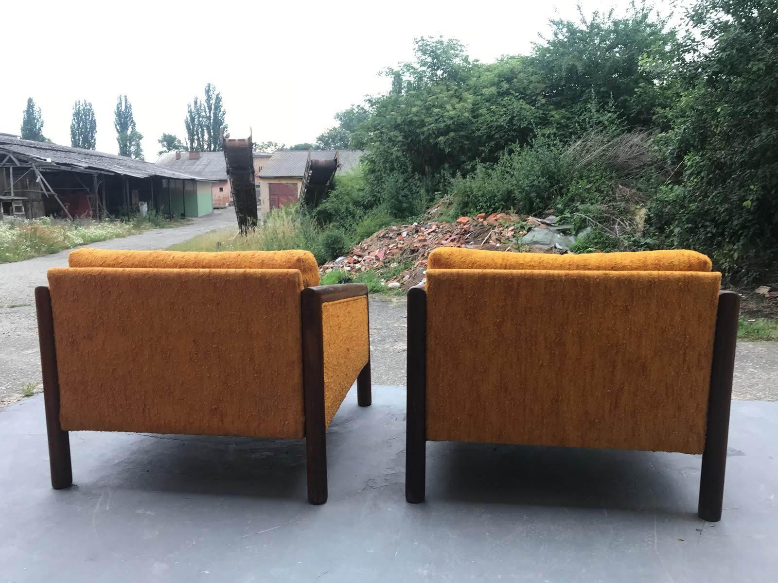 This pair of Mid-Century Modern armchairs featuring a beautifully grained sculpted walnut frame, a quintessential characteristic of legendary designer Adrian Pearsall. They were made in the 1960s by the Craft Associates in the USA. The cushions are