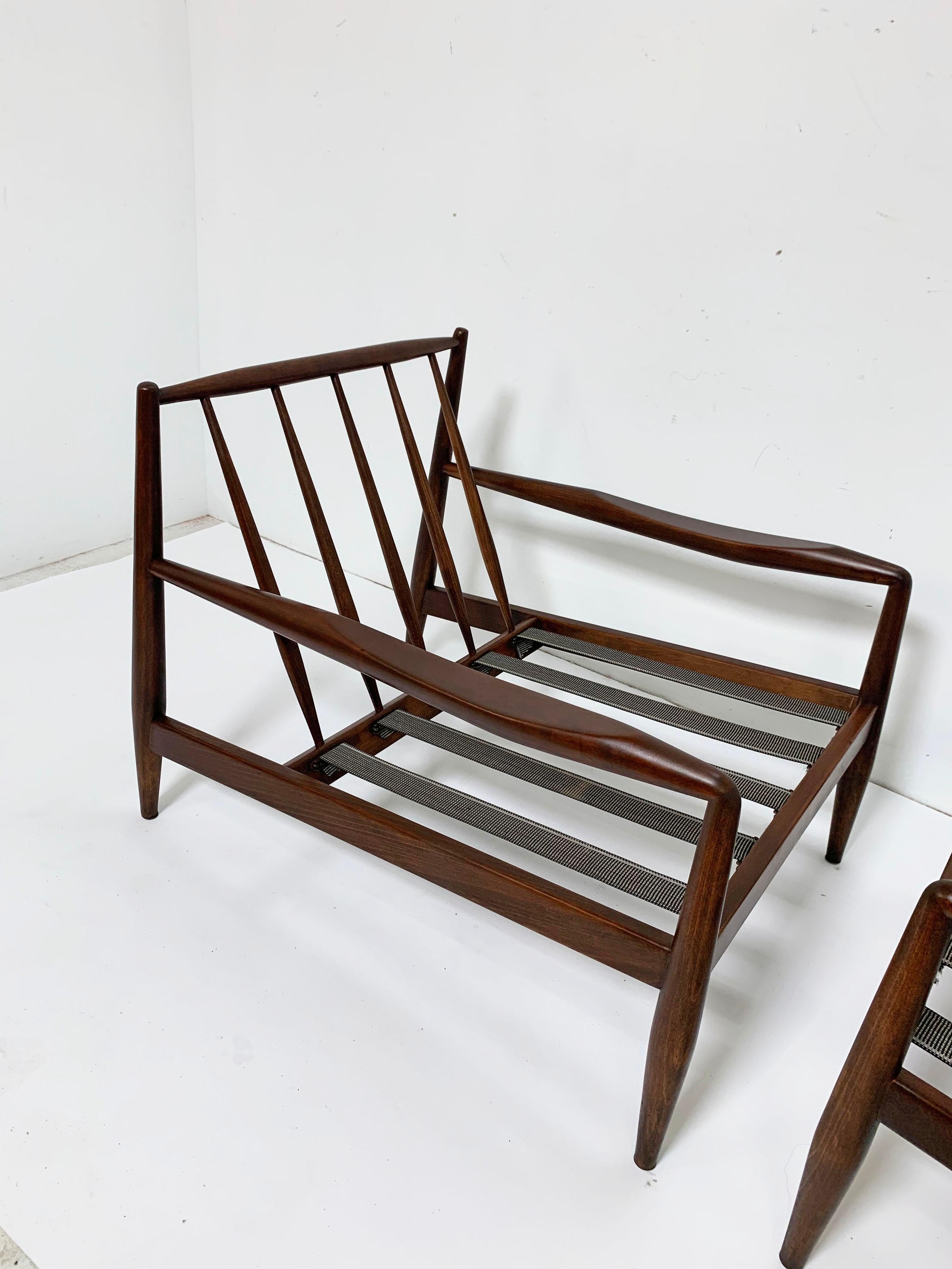 A pair of model 834-C lounge chairs in walnut by Adrian Pearsall for Craft Associates, circa 1960s. Newly re-webbed, but ready for customer's own upholstery. Dimensions listed are for the frame. Seat height listed of 11.75