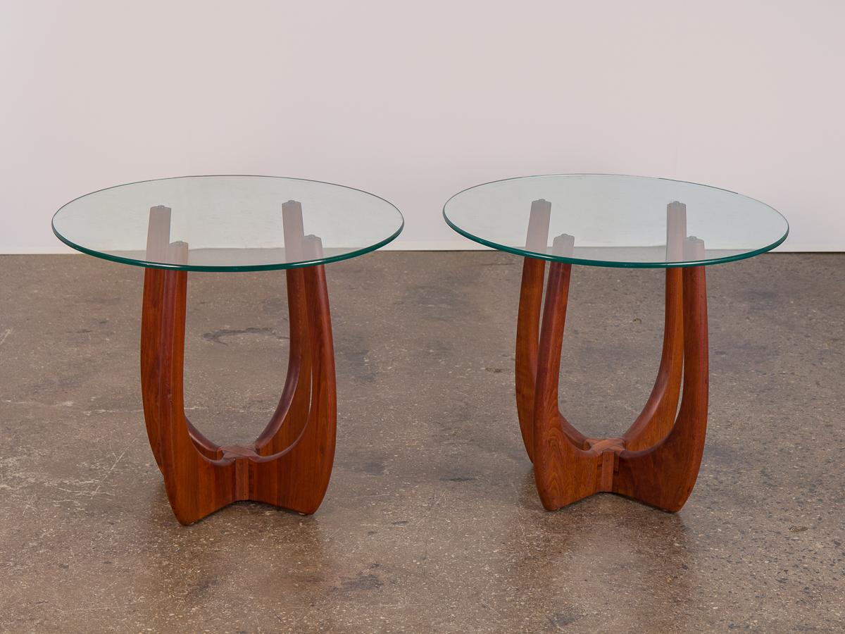 Fantastic matching set of American modern end tables by Adrian Pearsall. Organic, four-legged cross bases are elegantly sculpted, and have been cleaned and polished. Lightly tinted green circular glass is in good condition, with age-appropriate wear