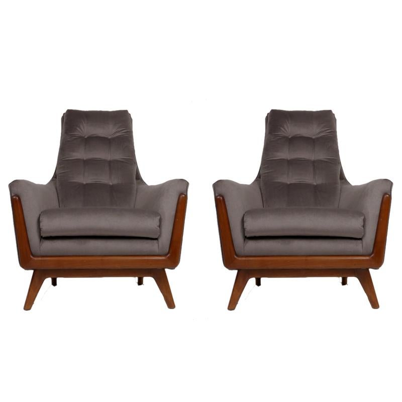 Freshly upholstered in a medium grey upholstery very comfortable walnut framed lounge chairs.