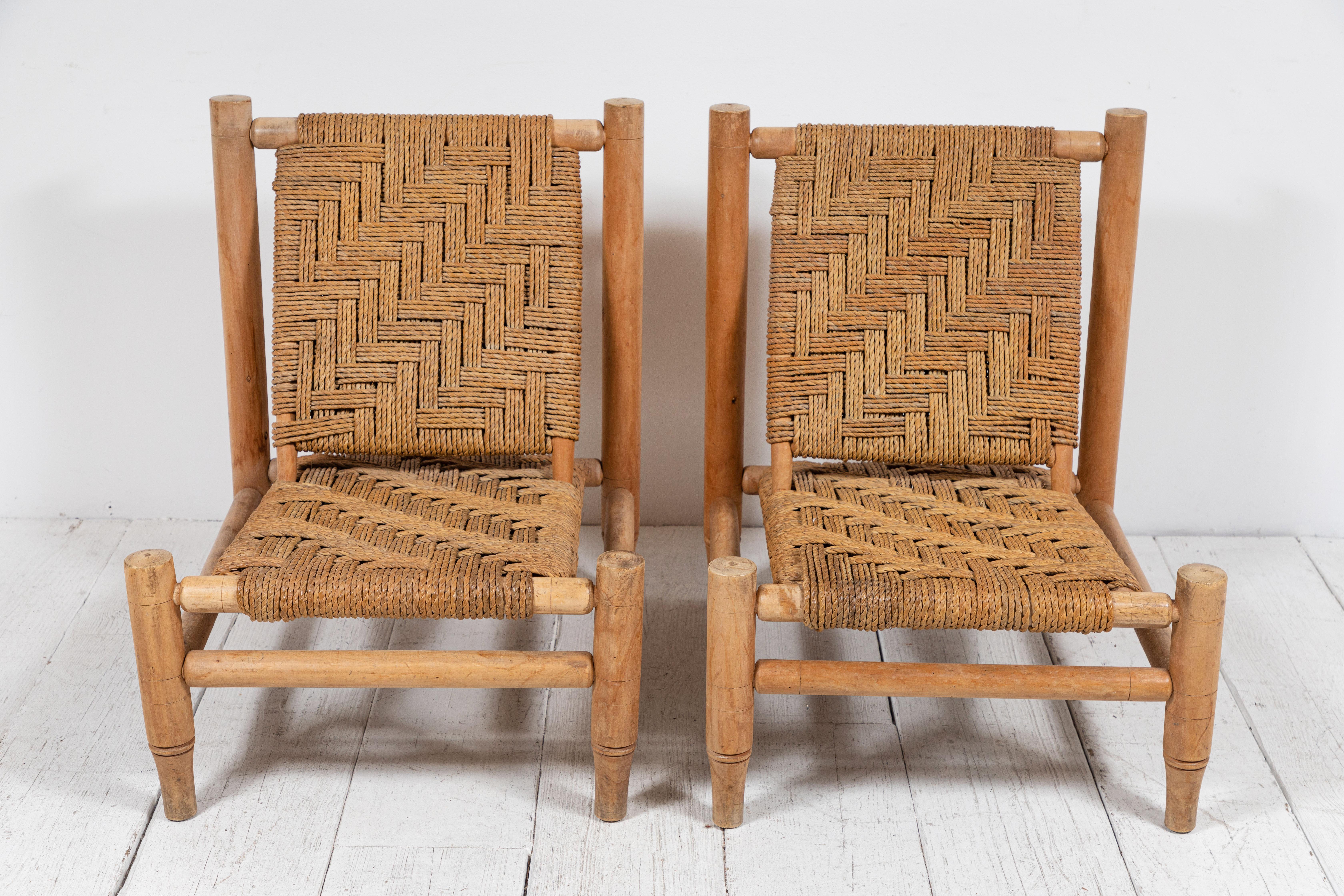Beautiful pair of French wood and rope chairs by Adrien Audoux & Frida Minet. The chairs offer a unique basket weave pattern. The rope is in great condition.