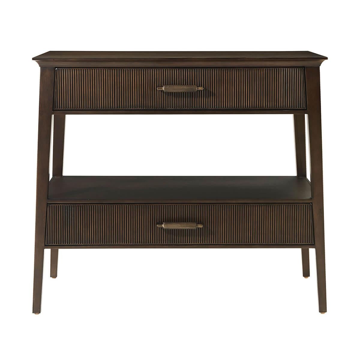 crafted from Prima Vera in our Bistre finish, features a sophisticated tapered silhouette with two long reeded drawers for storage. The custom forged hardware, finished in a dark rubbed bronze, echoes the reeded details throughout.

Dimensions: 32