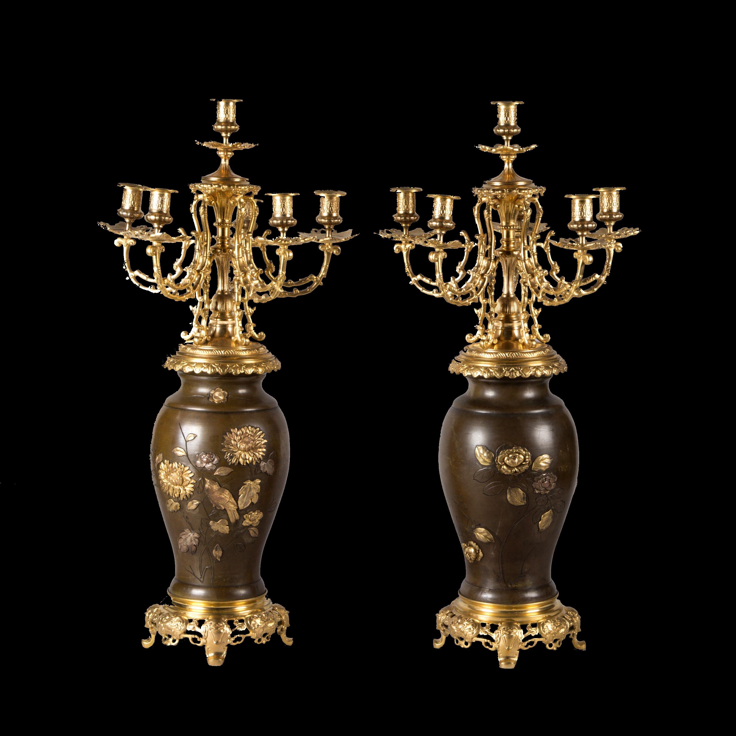 A beautiful and very large pair of Meiji period Japanese bronze vases with brown patina and caved design with applied gilt and silver bronze inserts representing birds and insects flying among peonies and chrysanthemums (