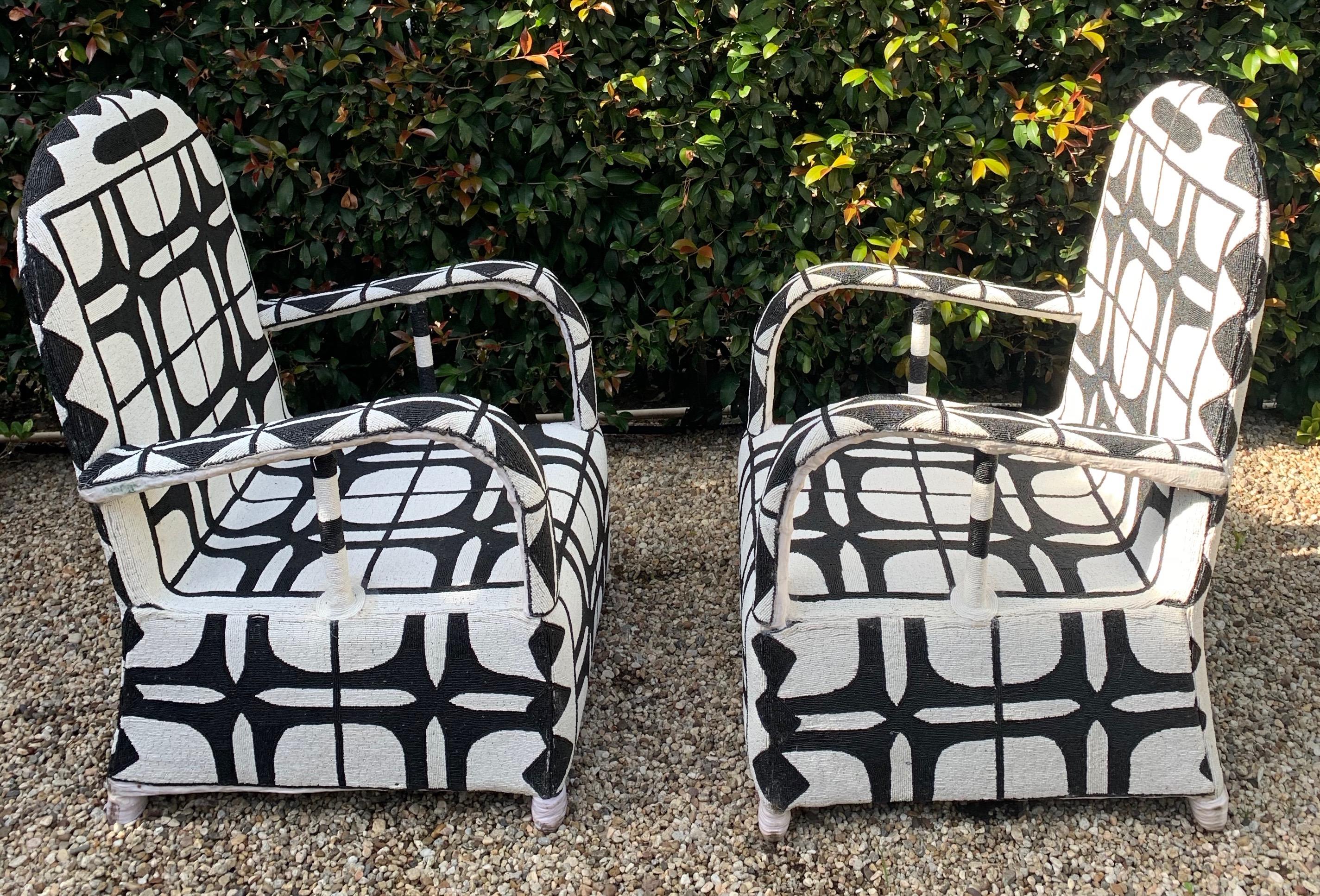 A Pair of handmade / beaded ceremonial Chairs. The chairs, made in Nigeria are custom and made with glass black and white beads to form the exquisite and very graphic pattern. A wonderful pair perfectly represented in many decors, modern or