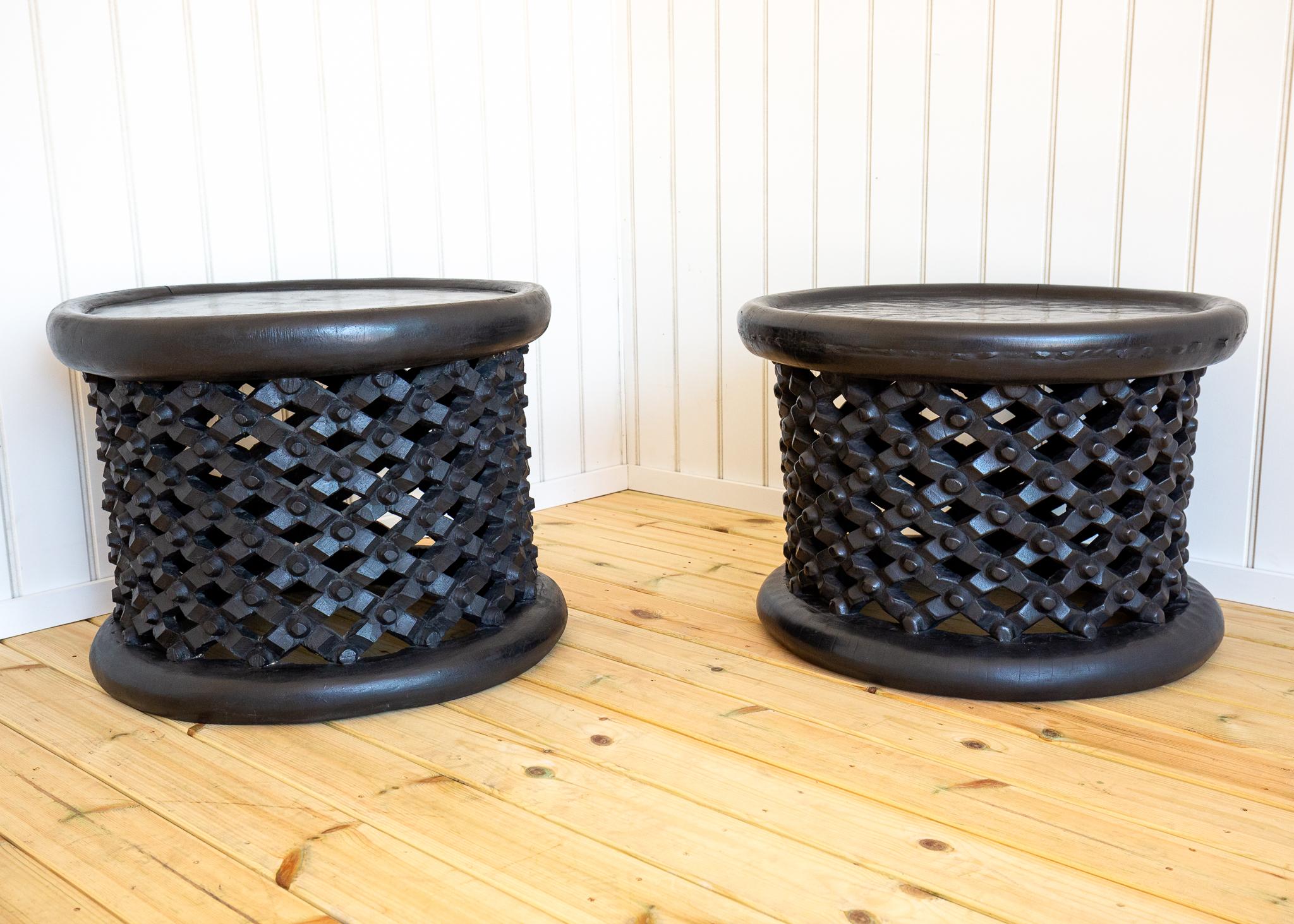 A gorgeous and rare pair of tribal African trunk-hewn Mid Century coffee tables in wonderful vintage condition. Crafted by the Bamileke people of the Western Highlands of Cameroon, most likely around 1950, this strikingly attractive and