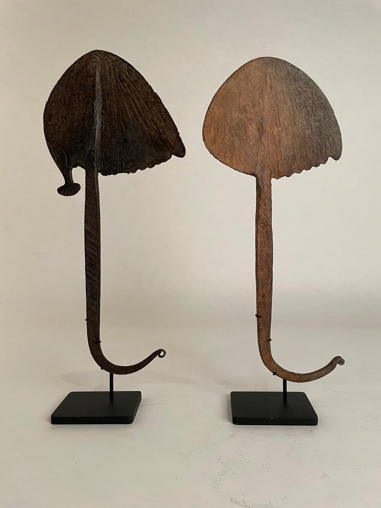 2 African iron Bandaka hoe currency, Mabila and Chamba Peoples, Nigeria and Cameroon. 
The iron, hammered into the form of a hoe, was used as currency. Mounted they are wonderful pieces of hand crafted sculpture steeped in culture and history. I