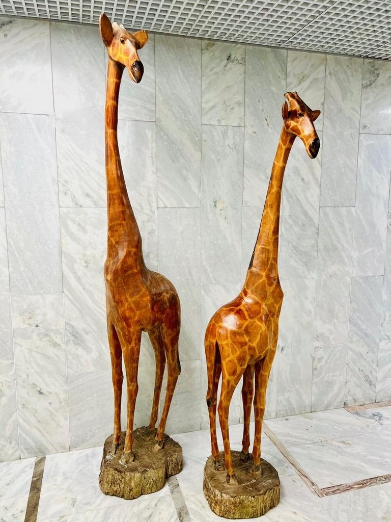 Mid-20th Century Natural size pair of african sculptures in noble wood representing giraffes  For Sale