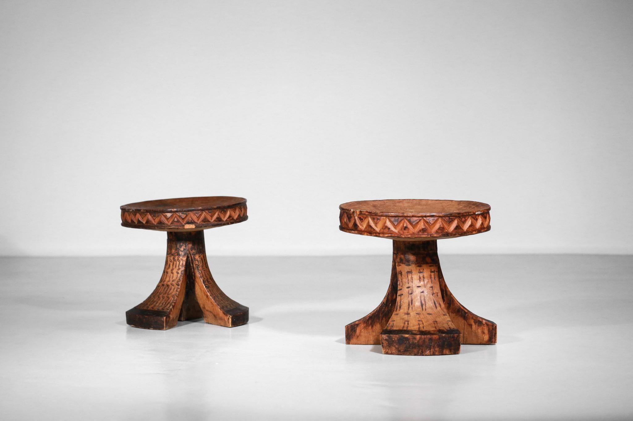 Duo of African solid wood stools carved from a single piece of wood.
Very decorative geometrical carvings on the legs and all around the seat.